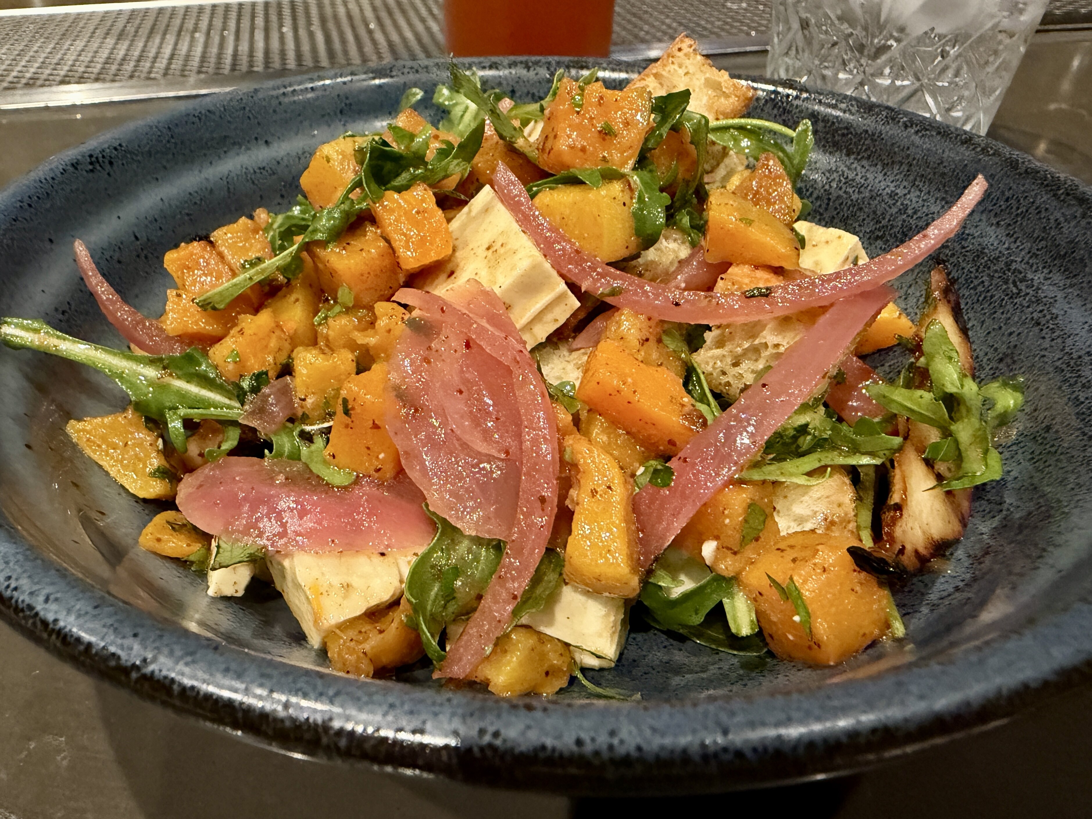 A plate of butternut squash and grilled pear panzanella at Costa Kitchen & Bar at Mar Monte Hotel in Santa Barbara, California
