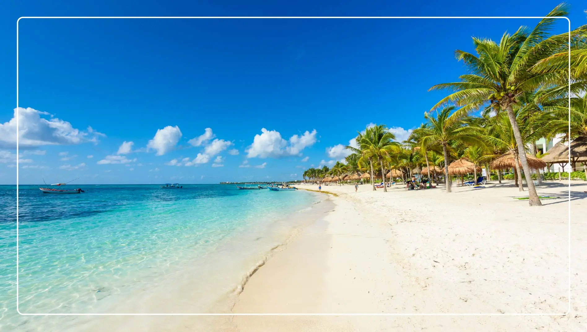 A beach in Cancun, Mexico with palm trees.