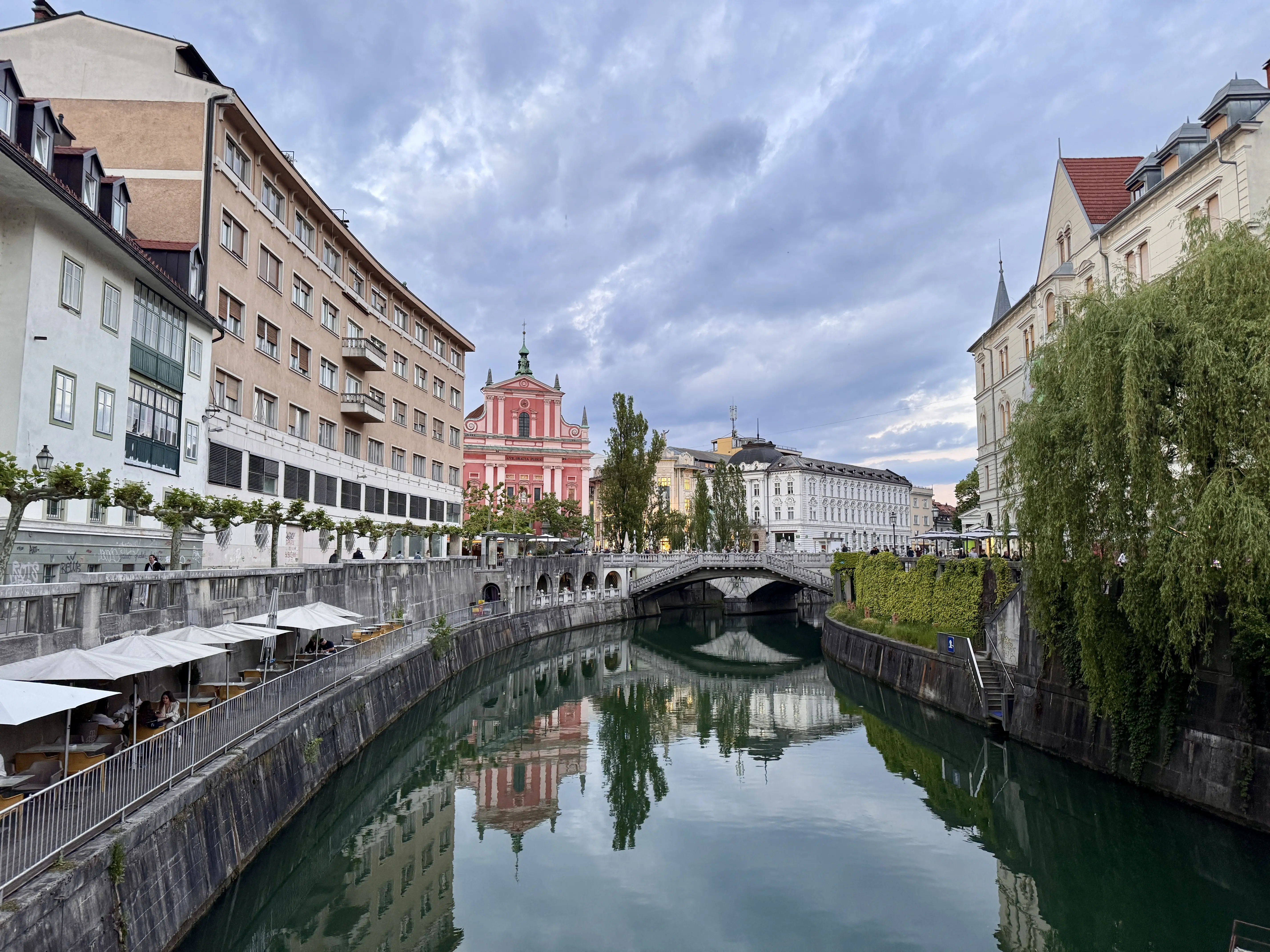 Image of a canal waterway and city street of Ljubljana.