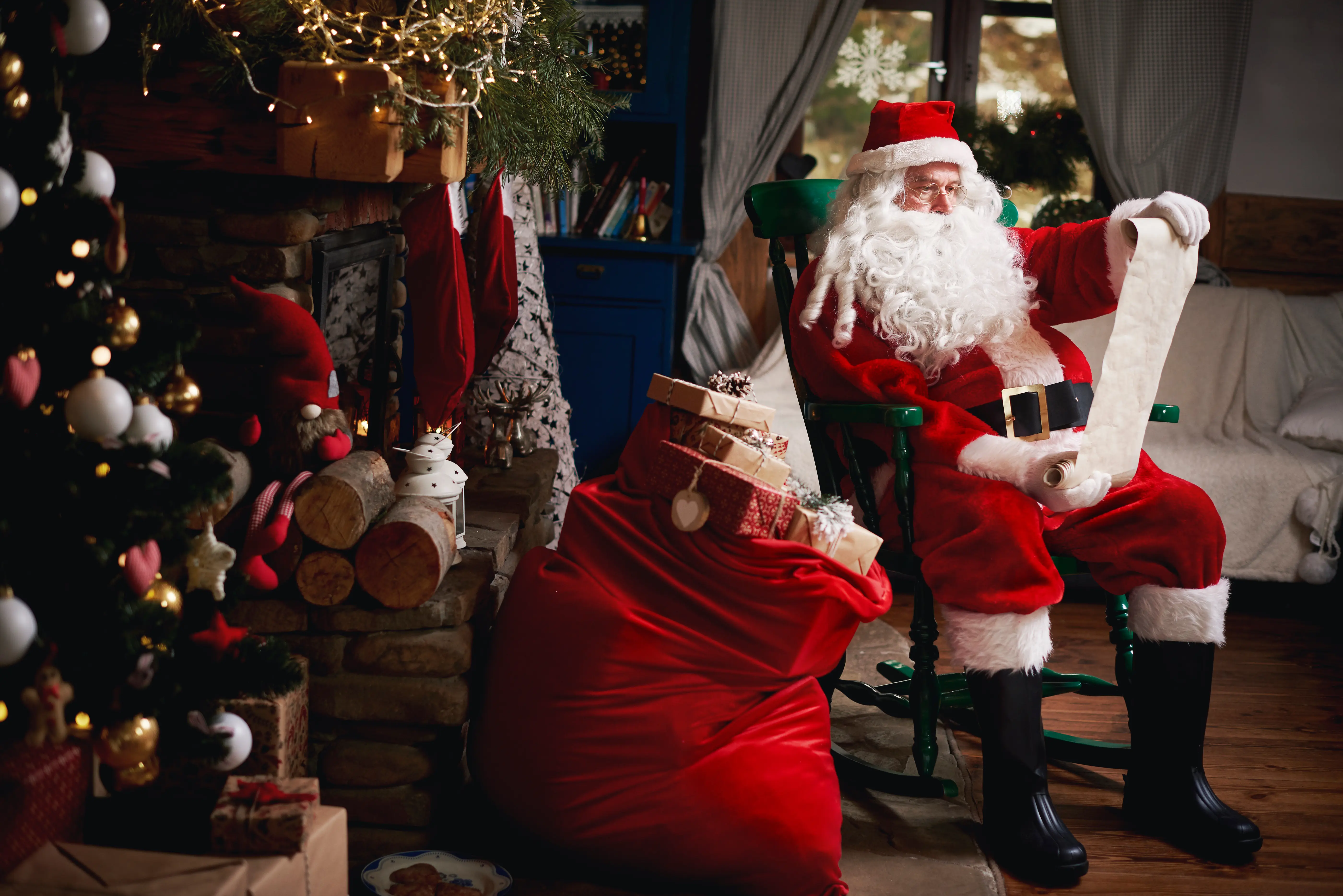 Image of Santa Claus sitting and checking his list.