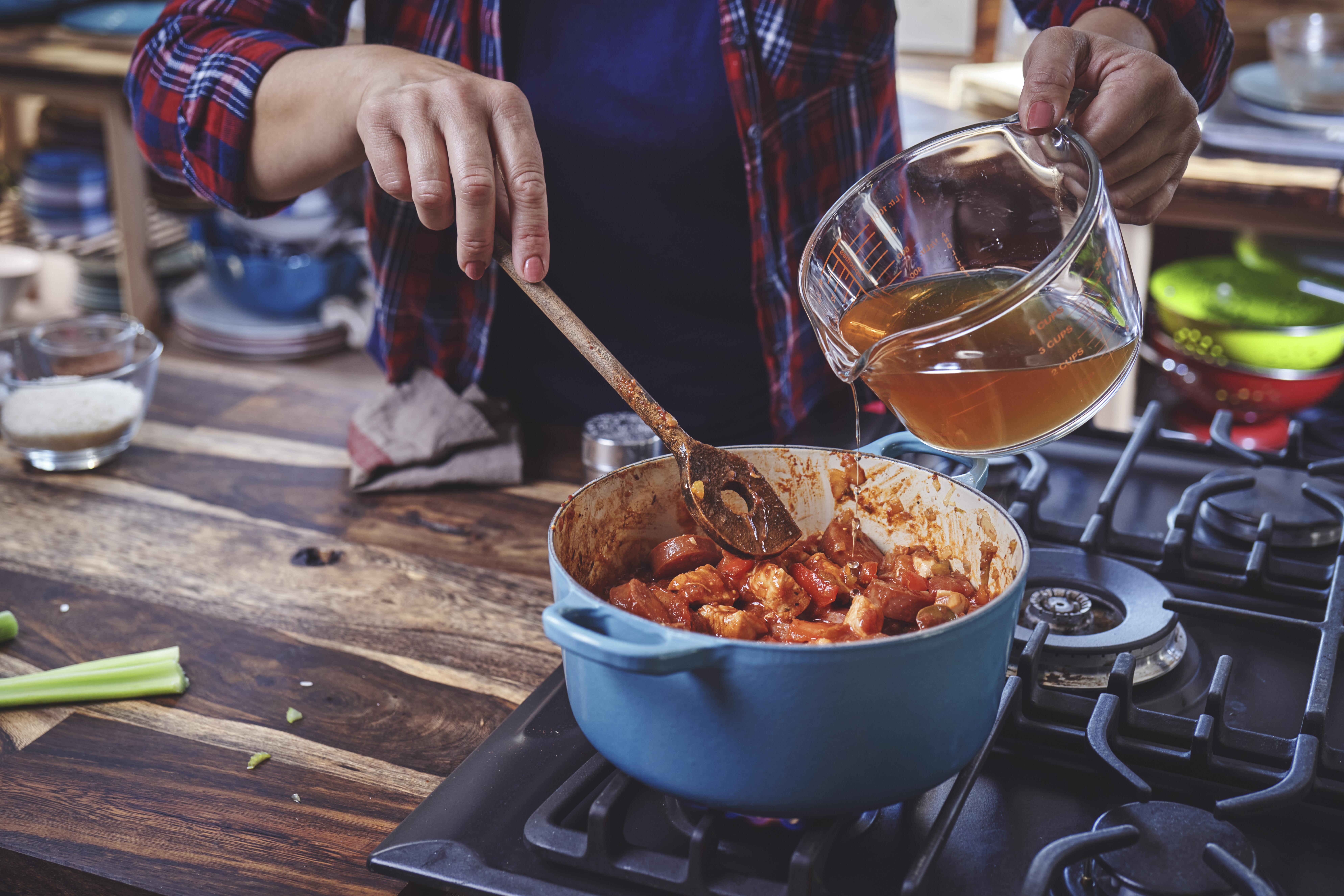 Preparing Cajun Style Chicken, Shrimp and Sausage Jambalaya in a Cast Iron Pot