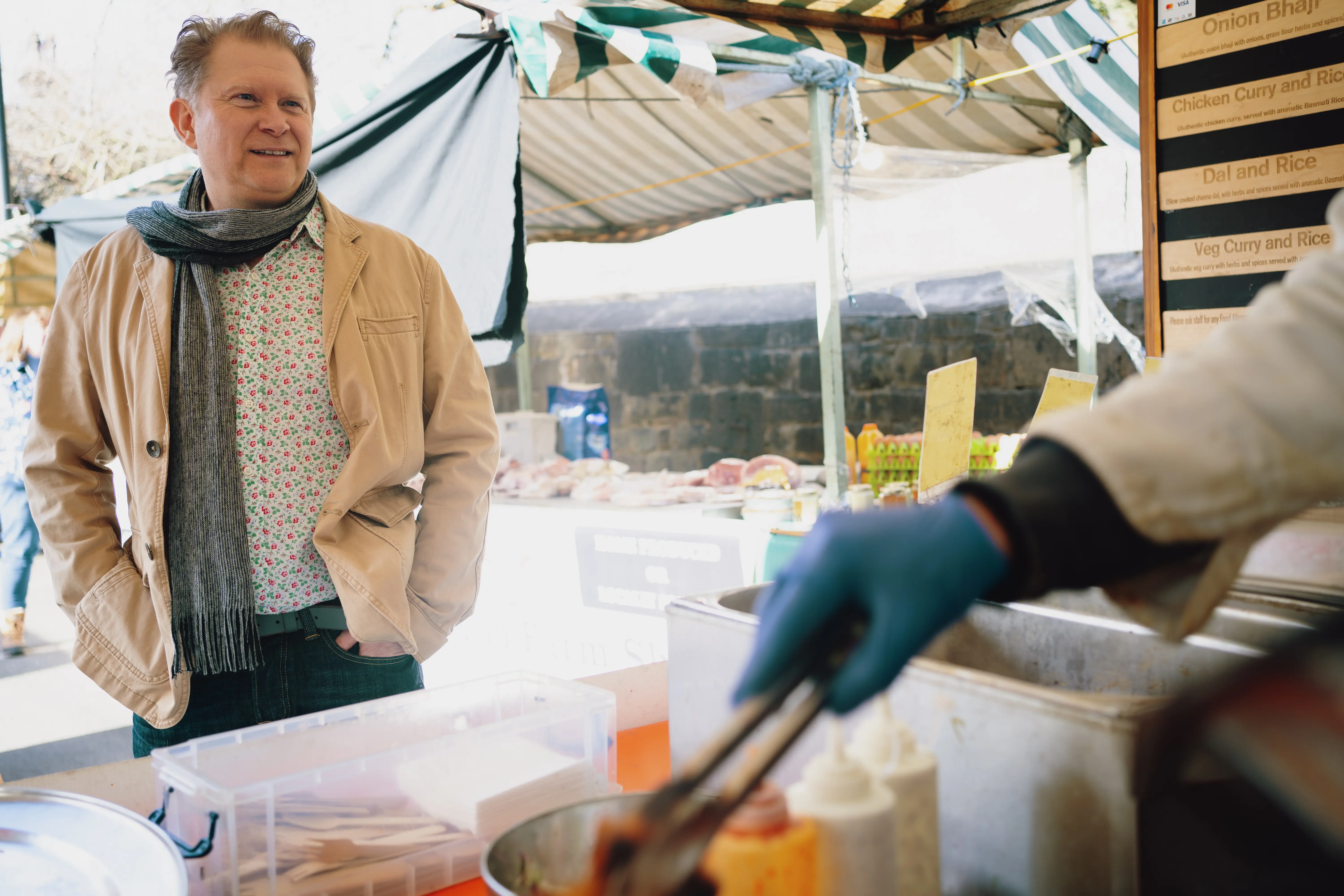 Outdoor image of a man getting food at a harbor market