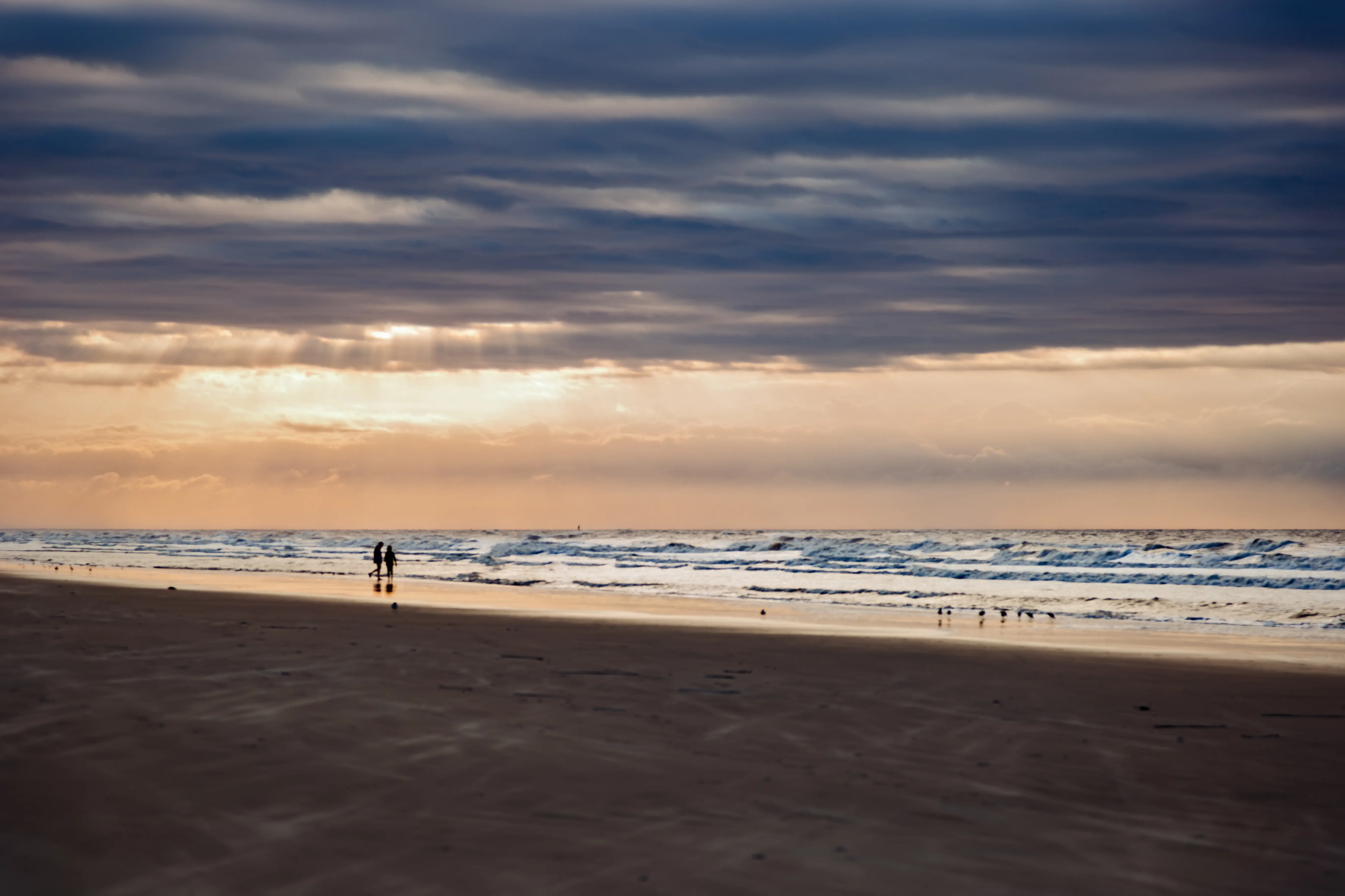 Image of a couple standing in the distance at Kiawah Island, South Carolina.