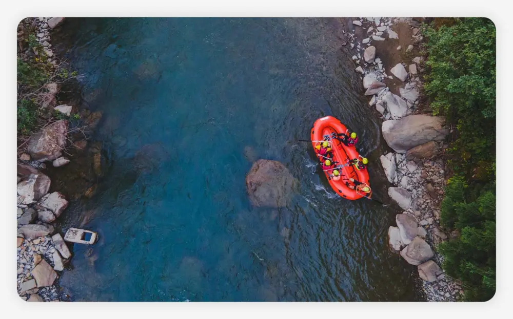 Aerial view of mountain river people rafting in creek