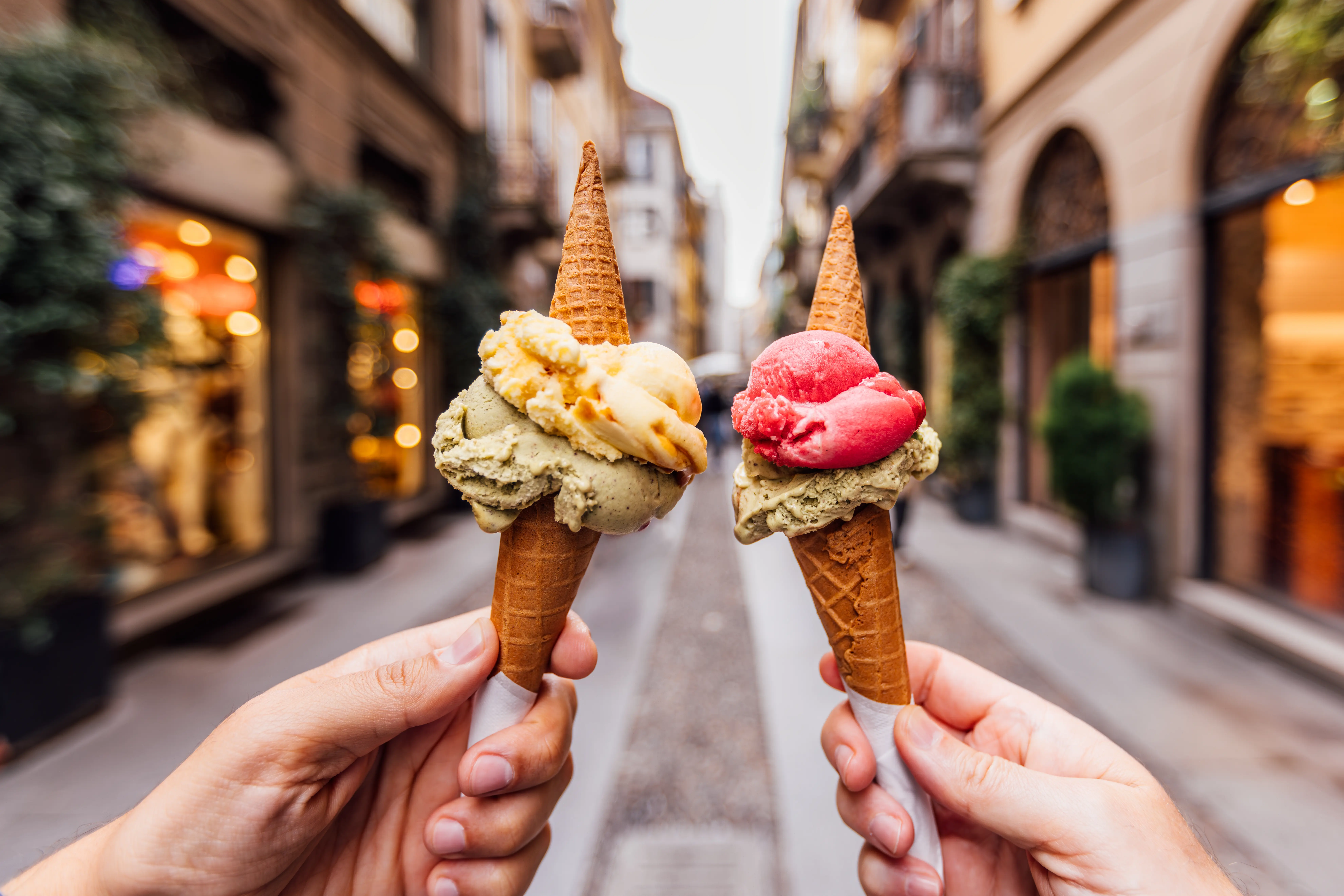 Photo of gelato in front of architecture in Milan, Italy