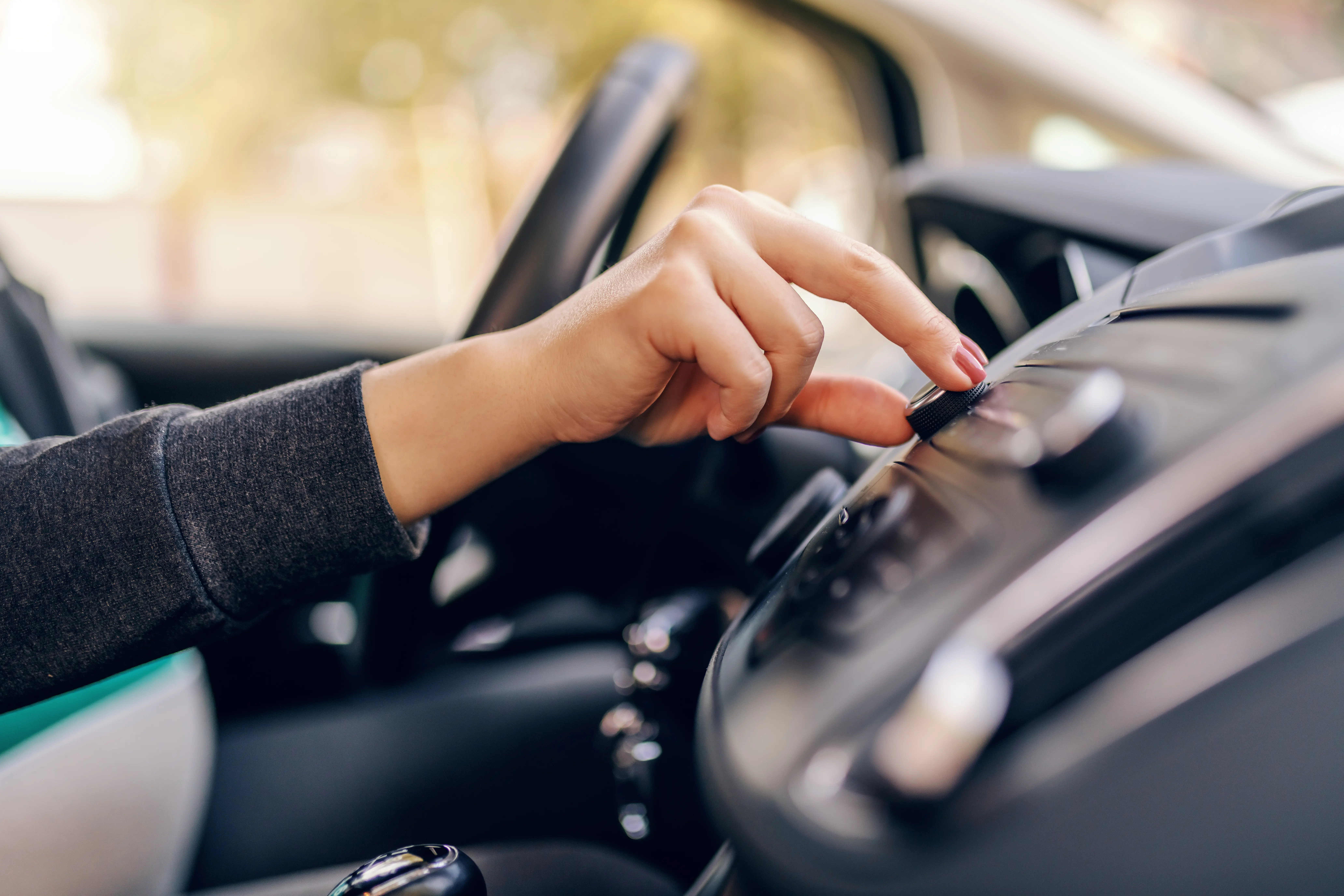 Adjusting the radio on a car trip while travelling