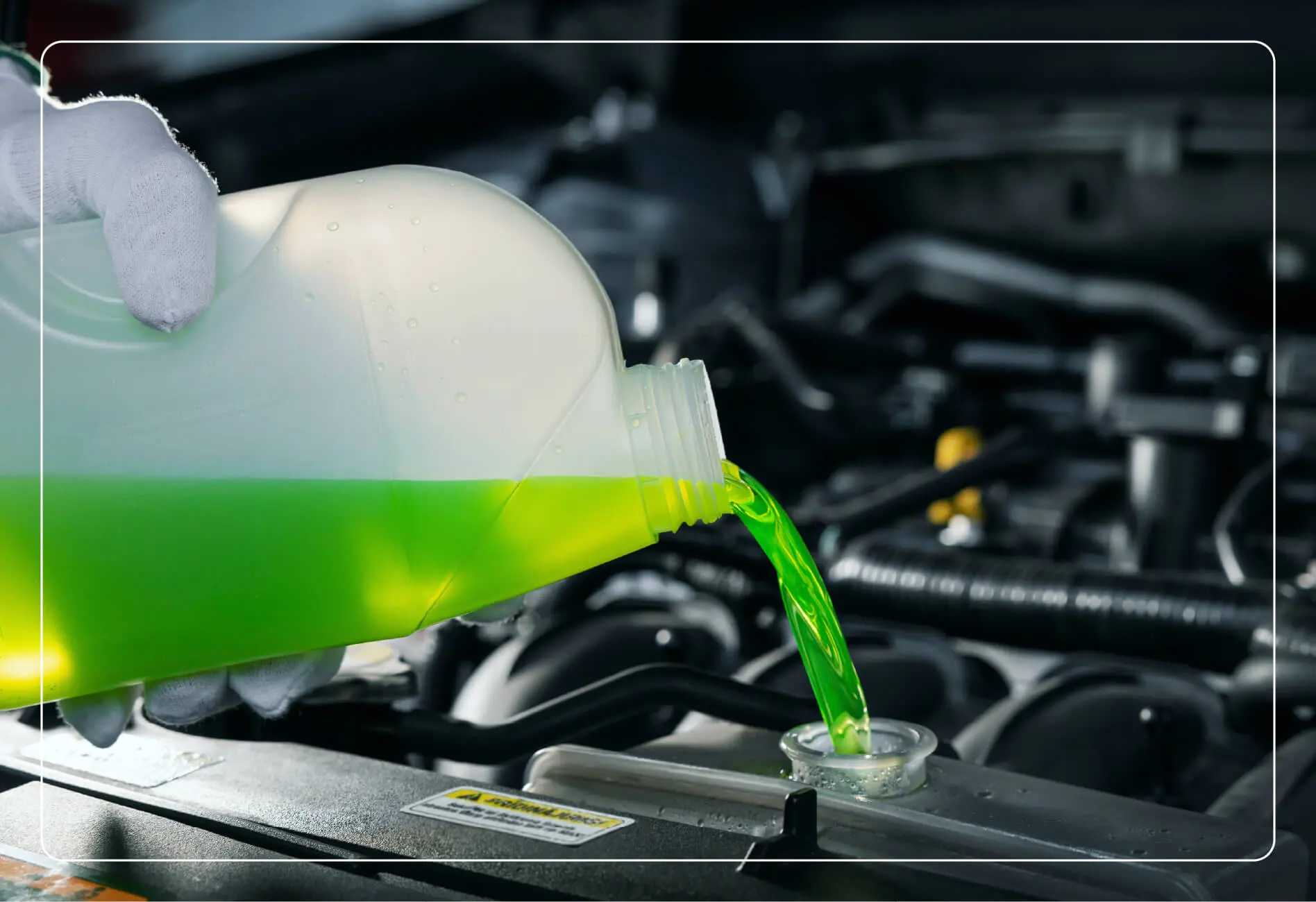 a mechanic pouring engine coolant into the reservoir