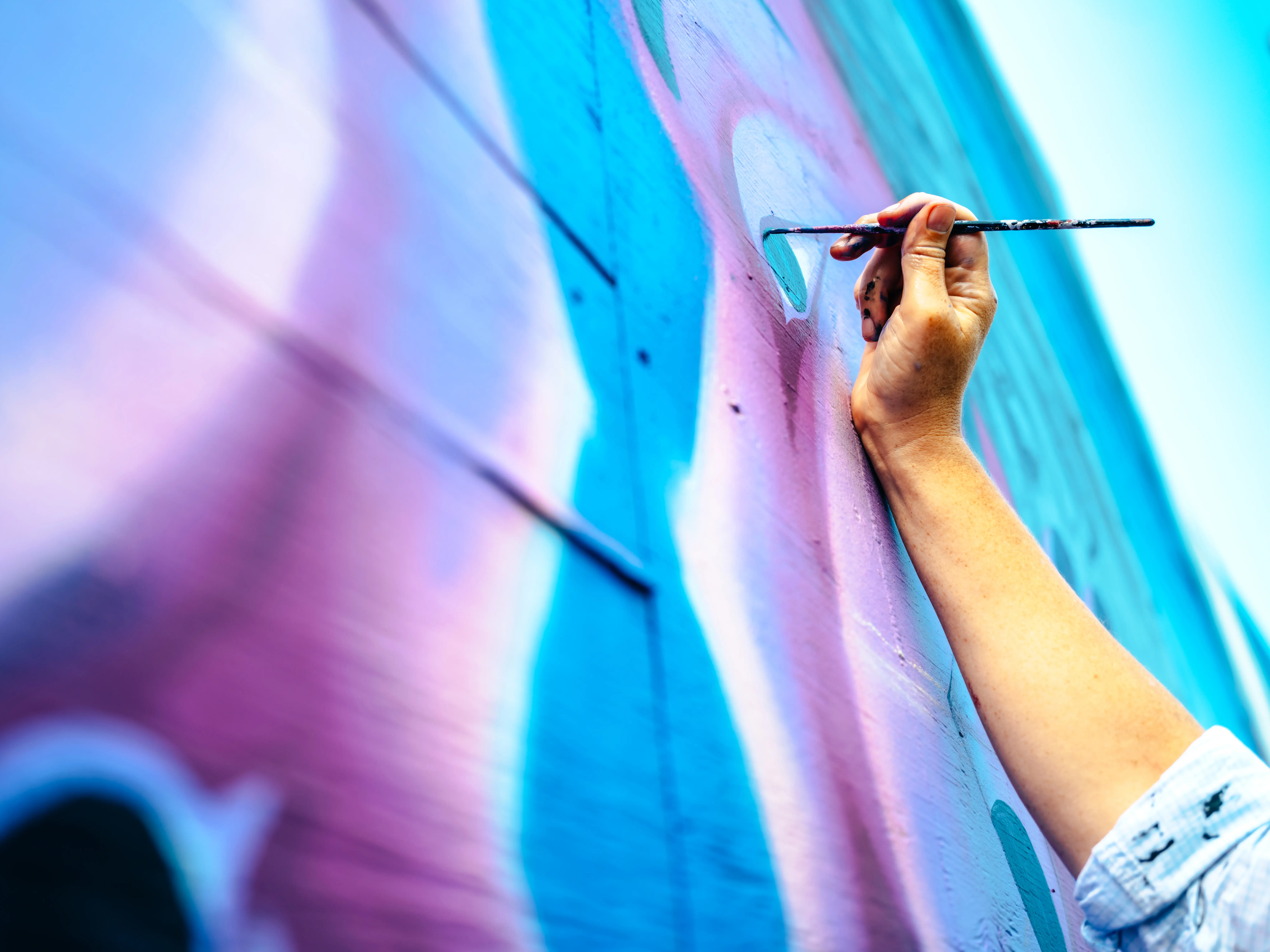 Hand of female mural artist at work