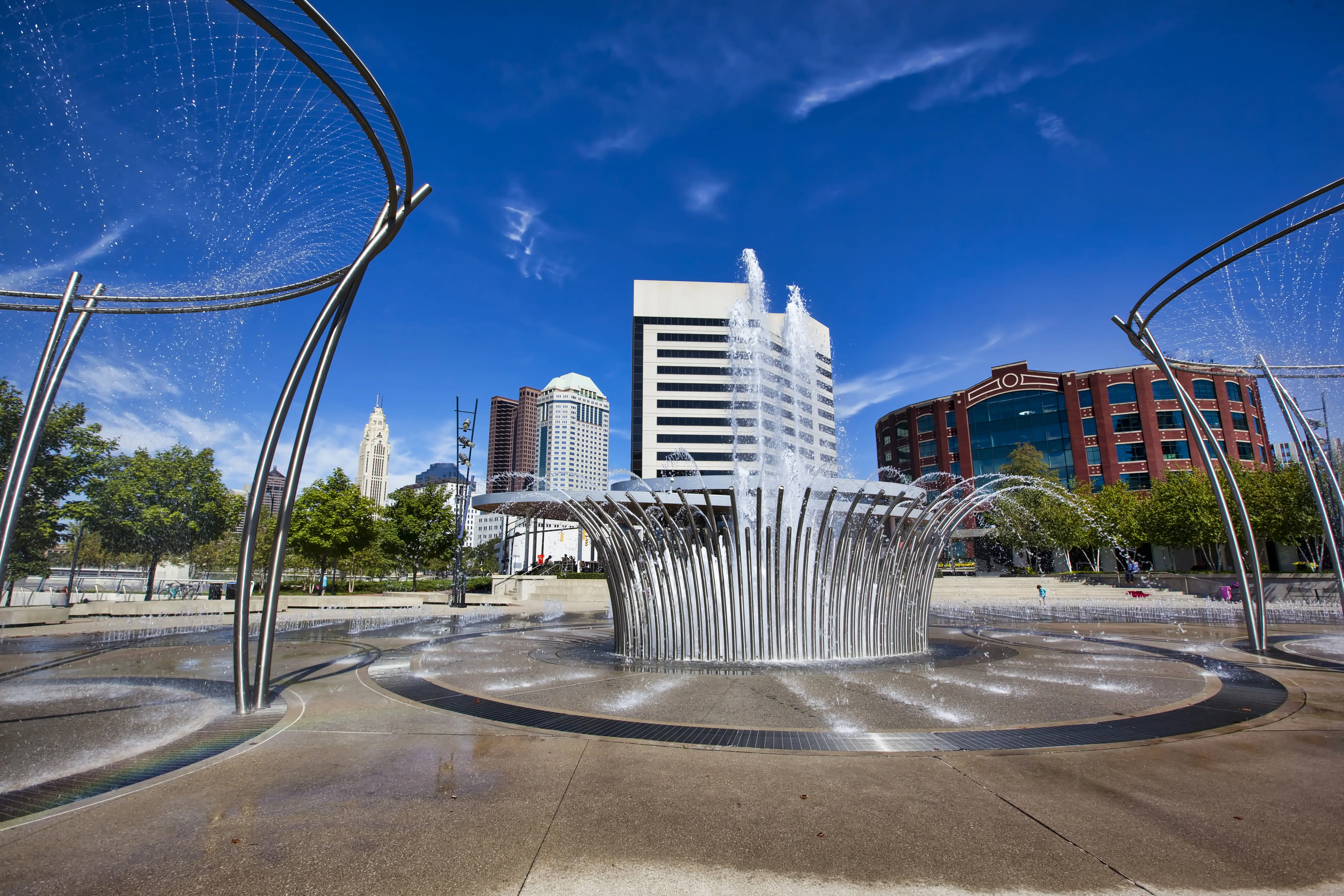 Sunny day urban fountains in Bicentennial Park with downtown Columbus buildings in background, Ohio