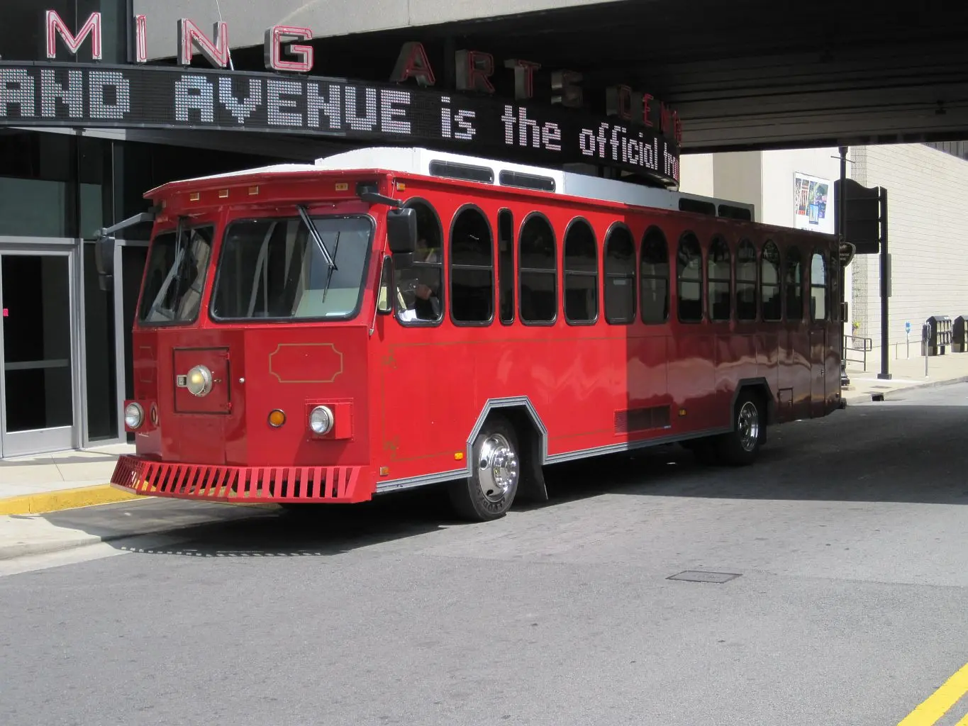 Outdoor picture of a red trolley-style tour bus in Nashville.