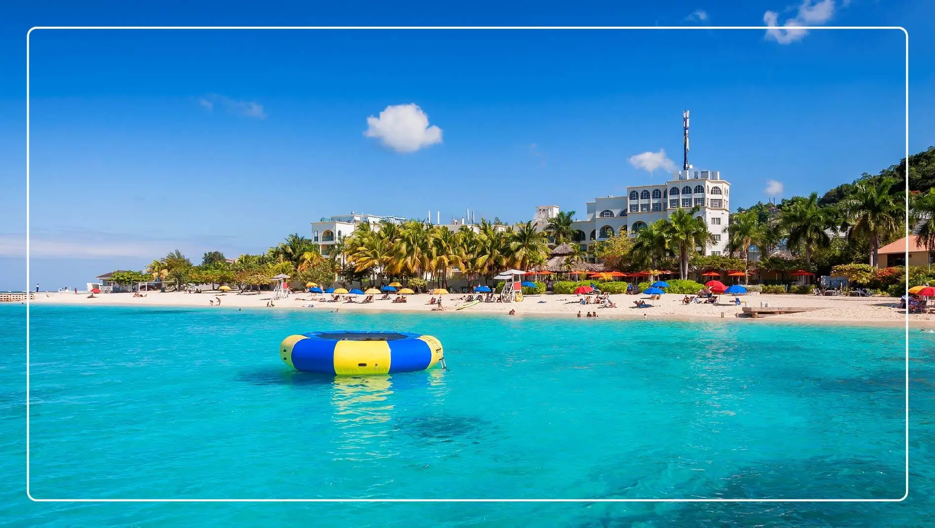 A large inner tube in the water just off a beach in Jamaica.