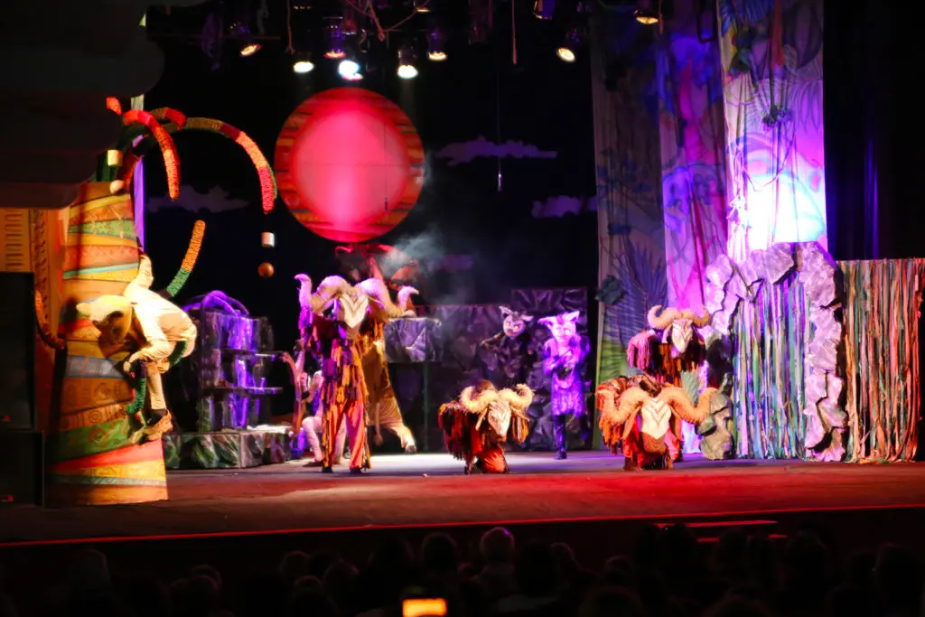 Picture of a stage performance of The Lion King musical.