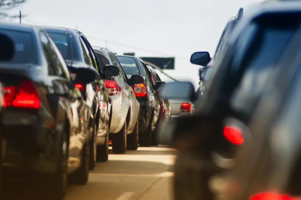 Cars stuck in traffic with their brake lights on.