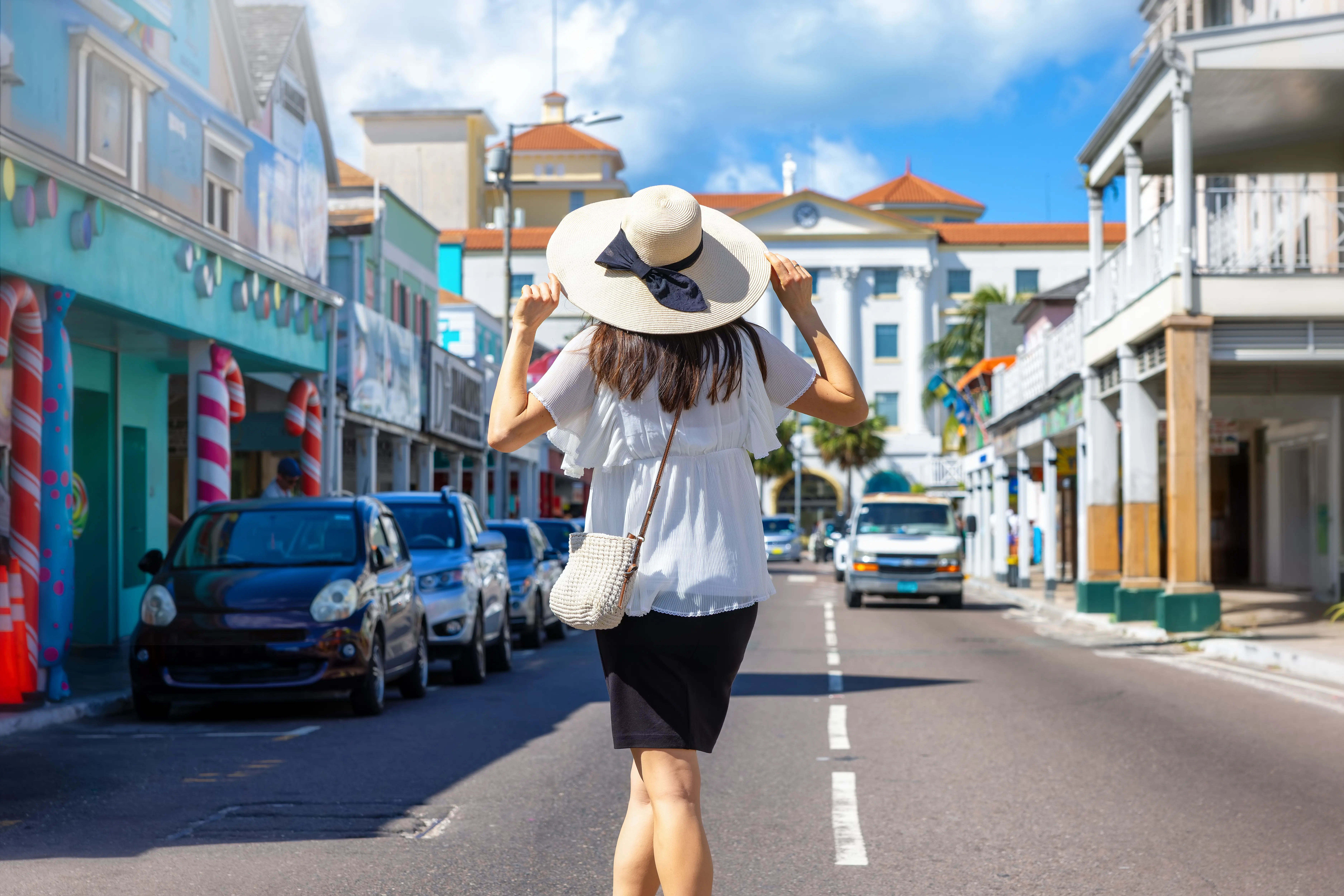A tourist woman on a sightseeing trip through the colourful streets of Nassau, Bahamas, Caribbean.