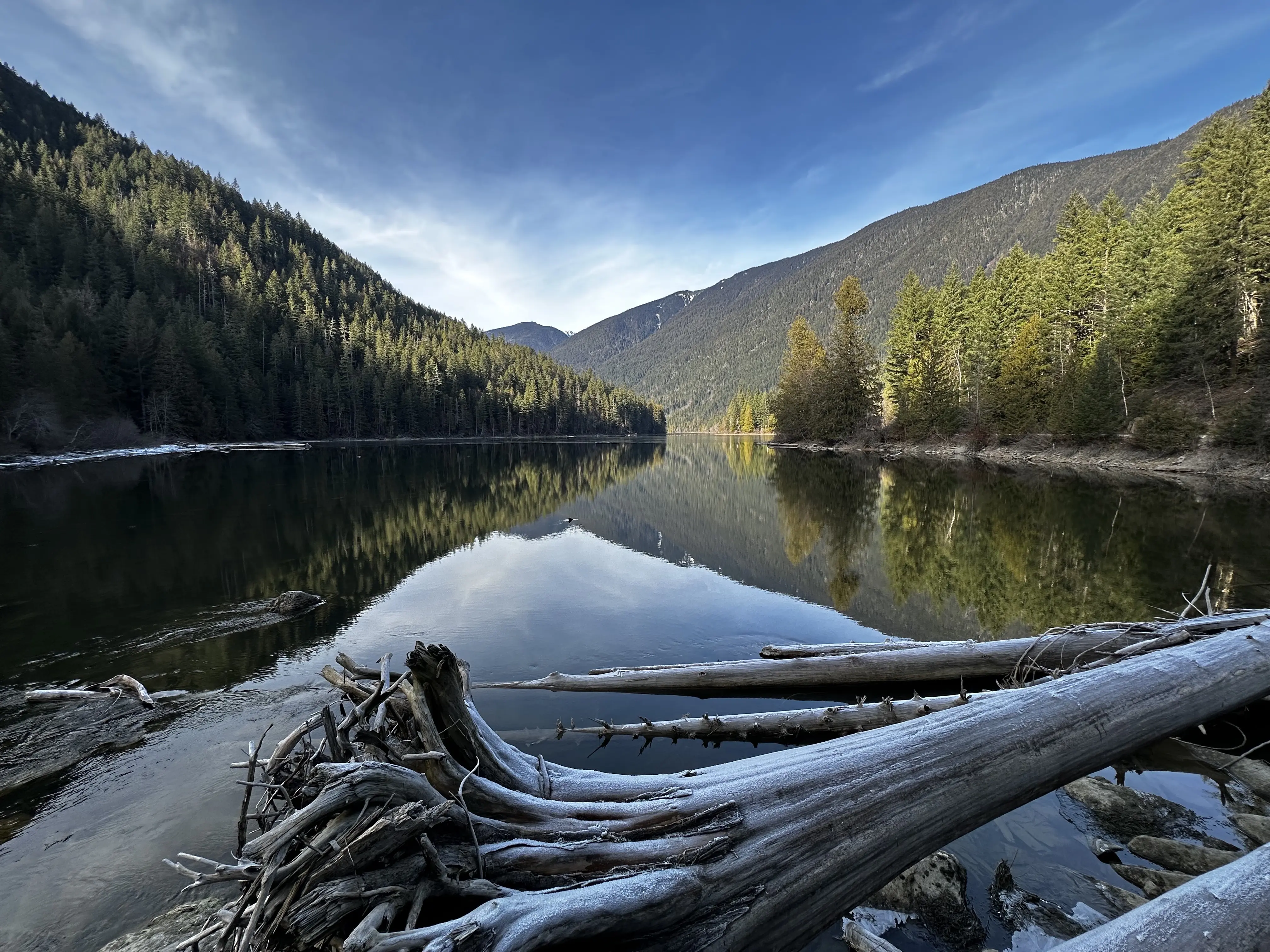 Image of the wilderness landscape of Talapus Lake in Washington, including the water, trees and mountains.