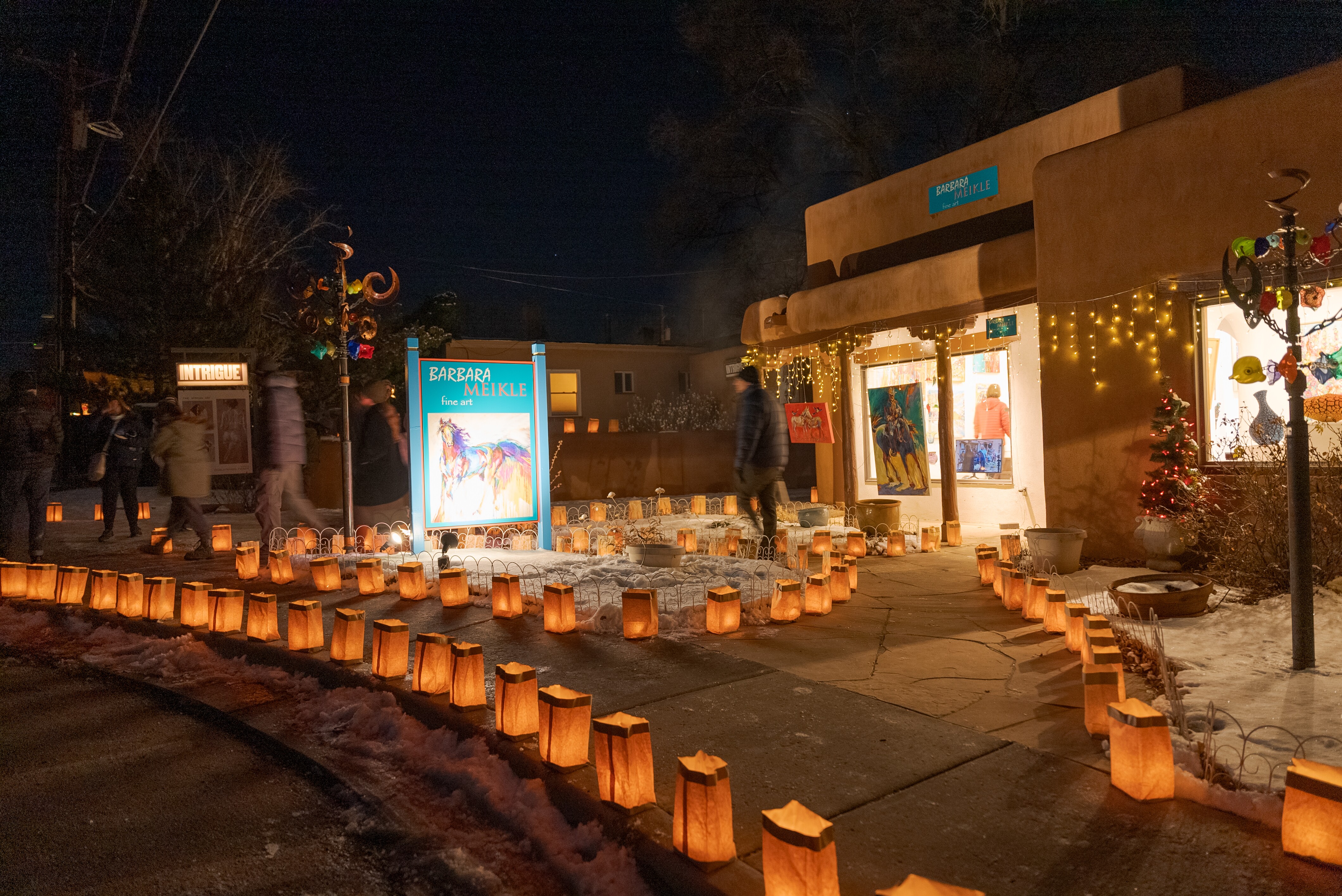 Adobo style building lit by luminarias at night