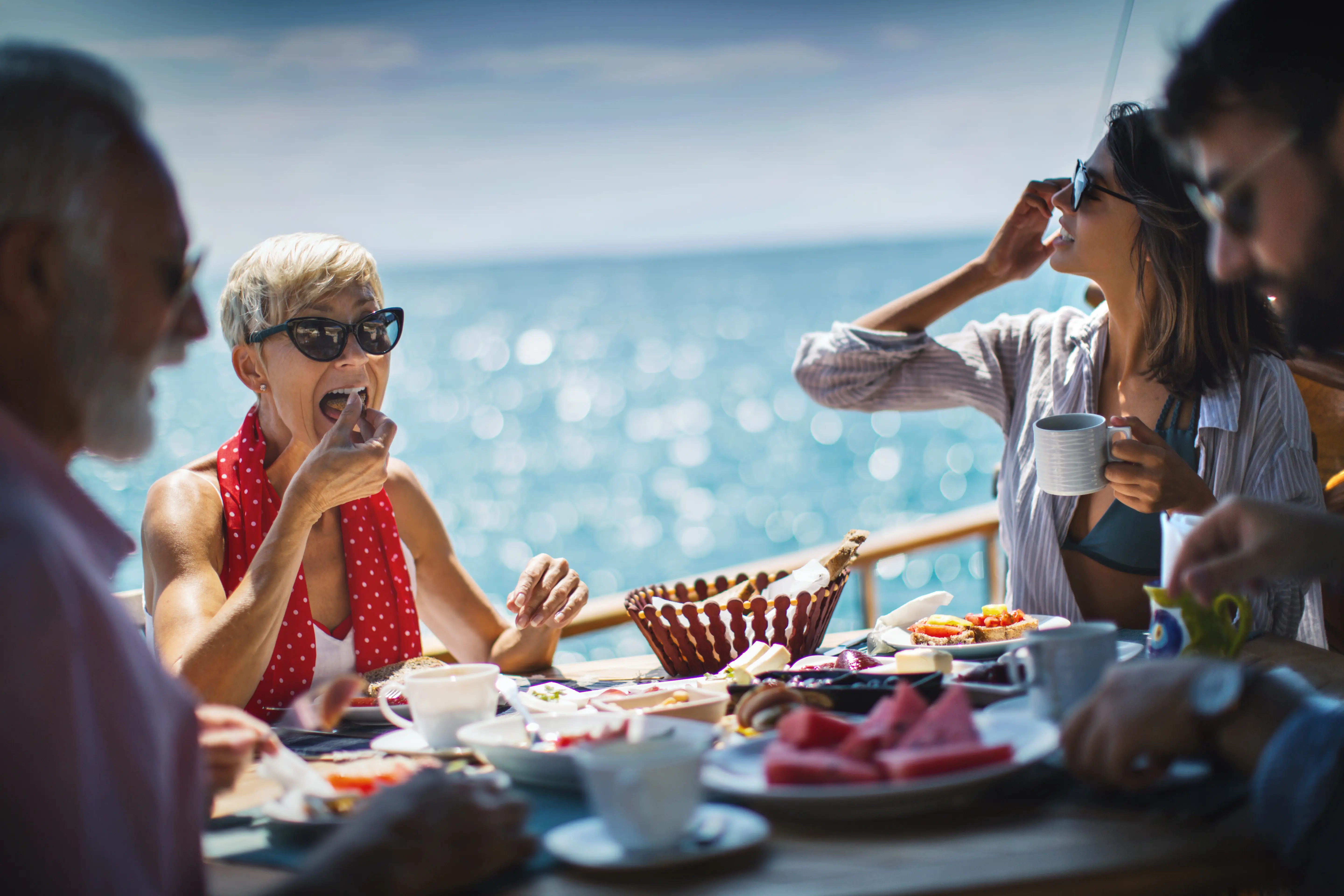 Image of a group eating outside on a cruise ship deck.