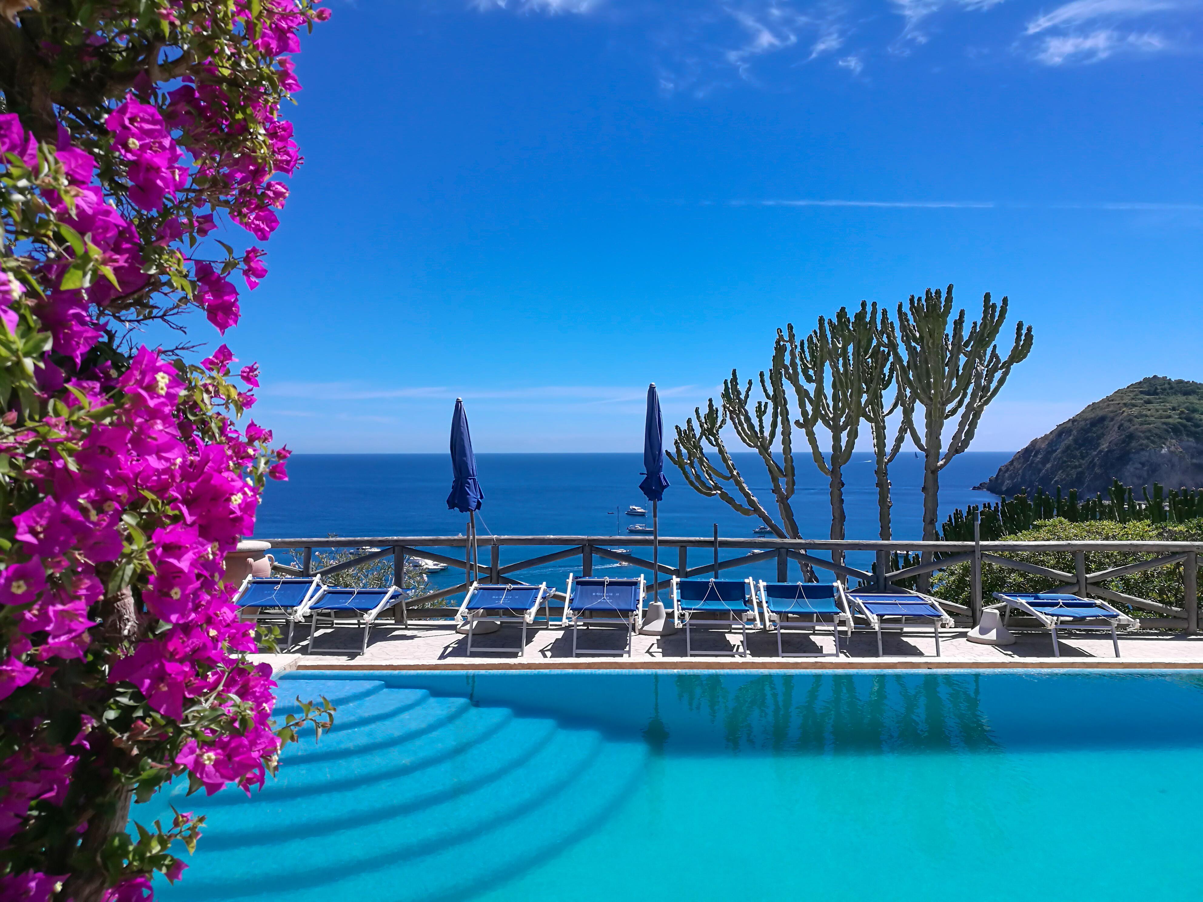 Swimming pool with sea in the background Ischia Island, Italy