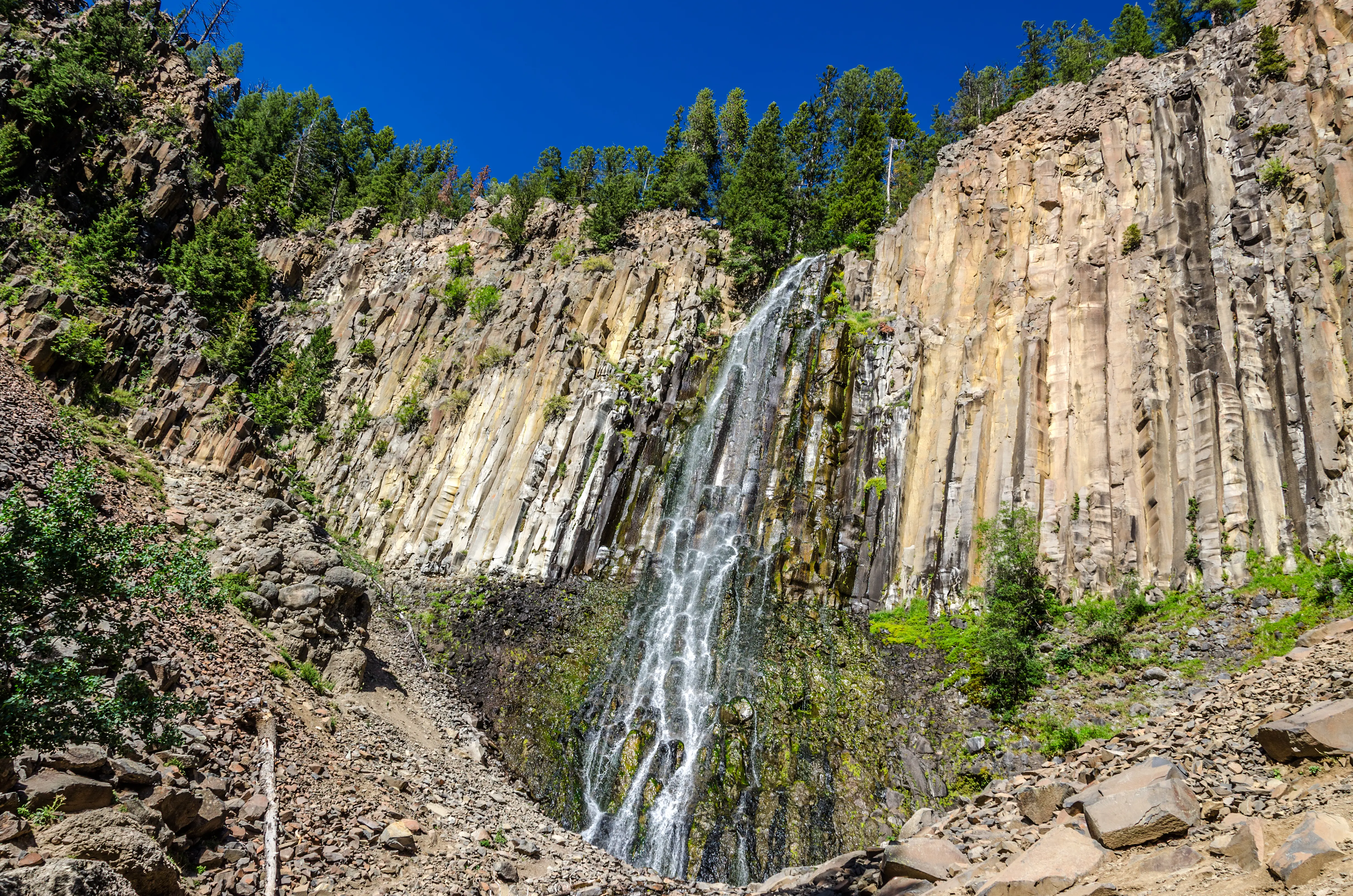 Blue sky sunny day at Palisade Falls in Hyalite Canyon near Bozeman, Montana, showing an excellent example of columnar jointing