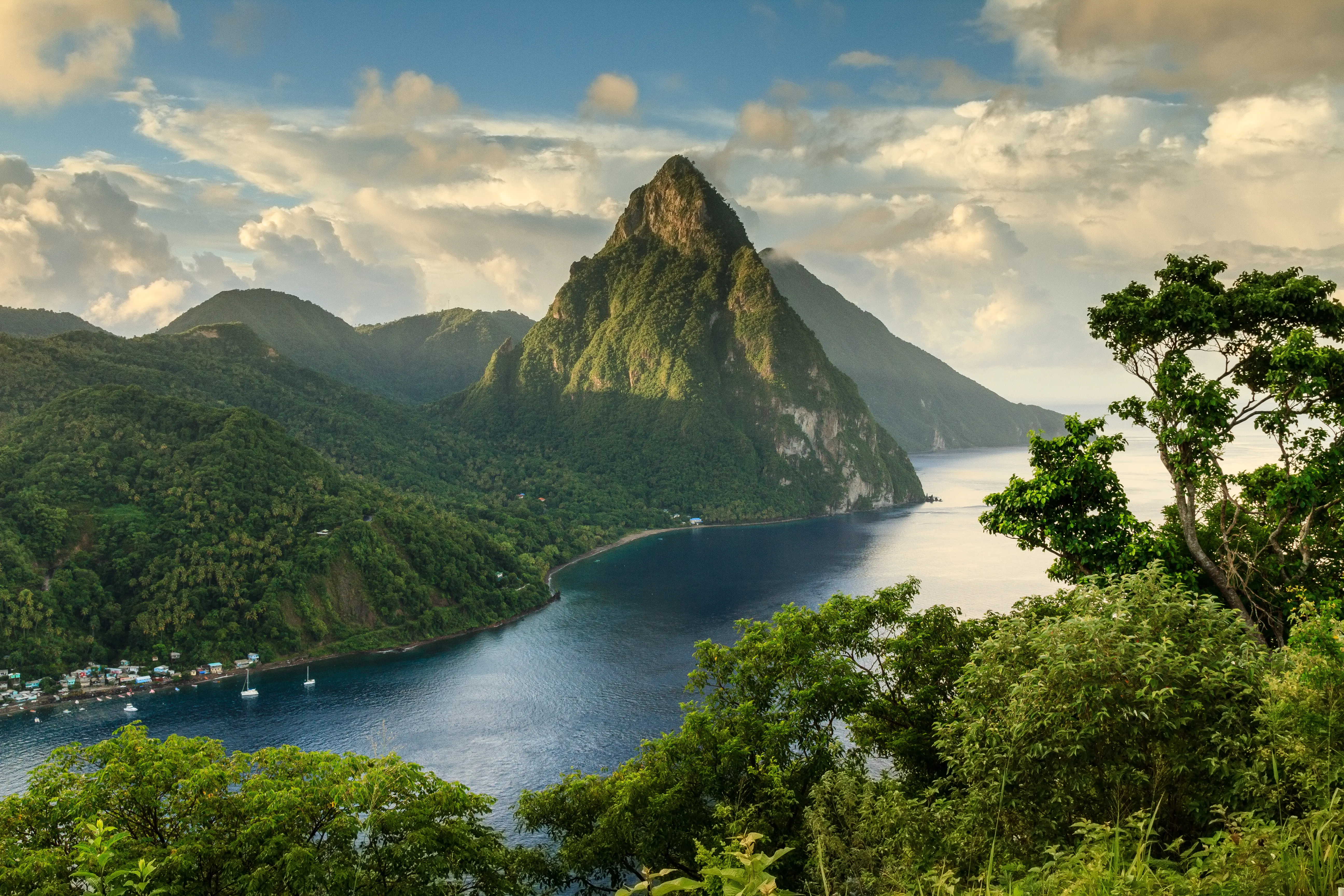 Aerial view of the Pitons (Petit Piton & Gros Piton) from an elevated viewpoint with the rainforest and bay of Soufrière in the foreground.