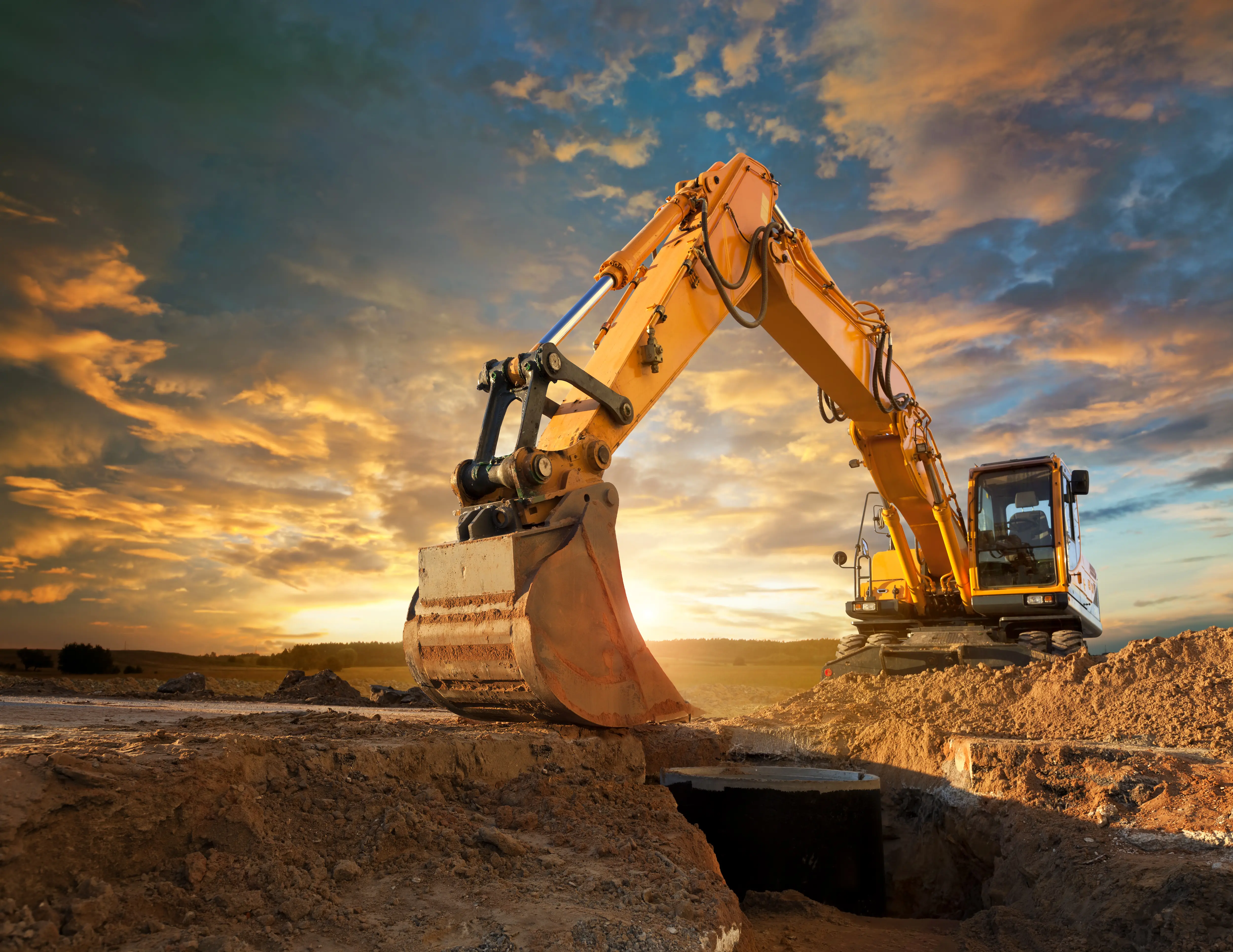 Outdoor image of an excavator at a construction site.
