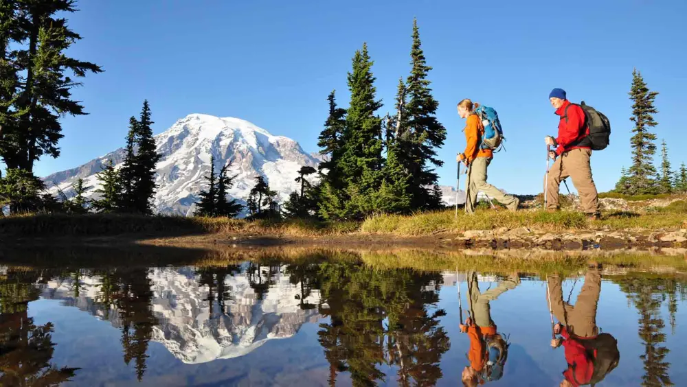 Couple hiking at Mount Rainer National Park, a popular thing to do in Seattle.