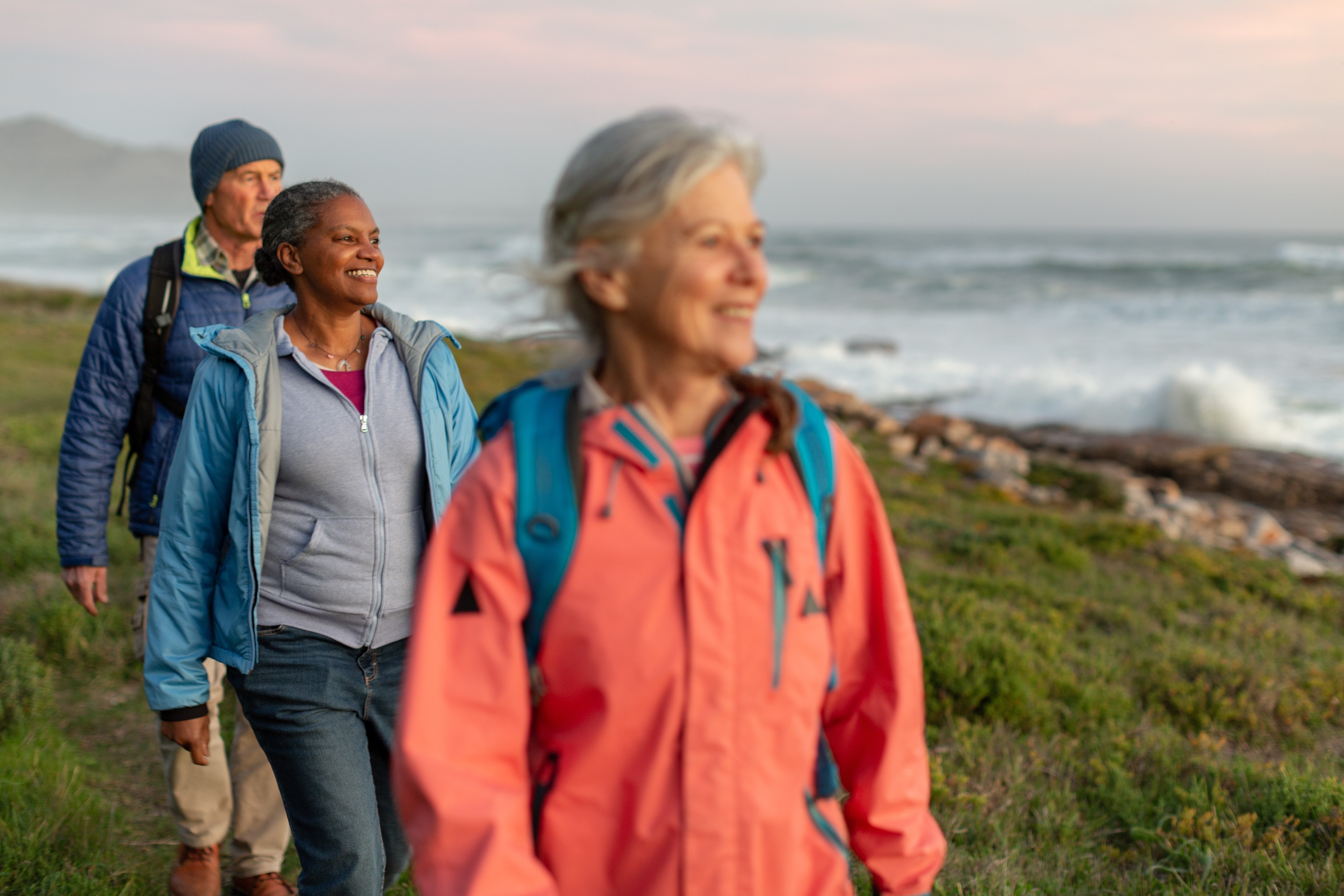 Image of seniors on a hike by the shore.