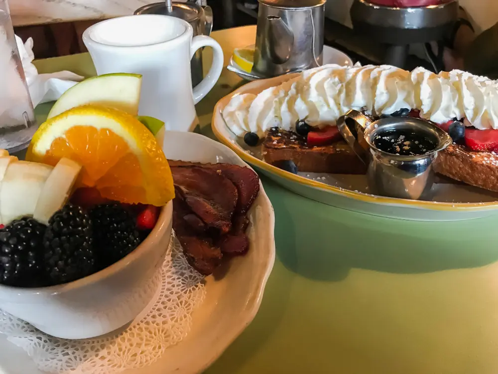 French toast breakfast with fruit and bacon