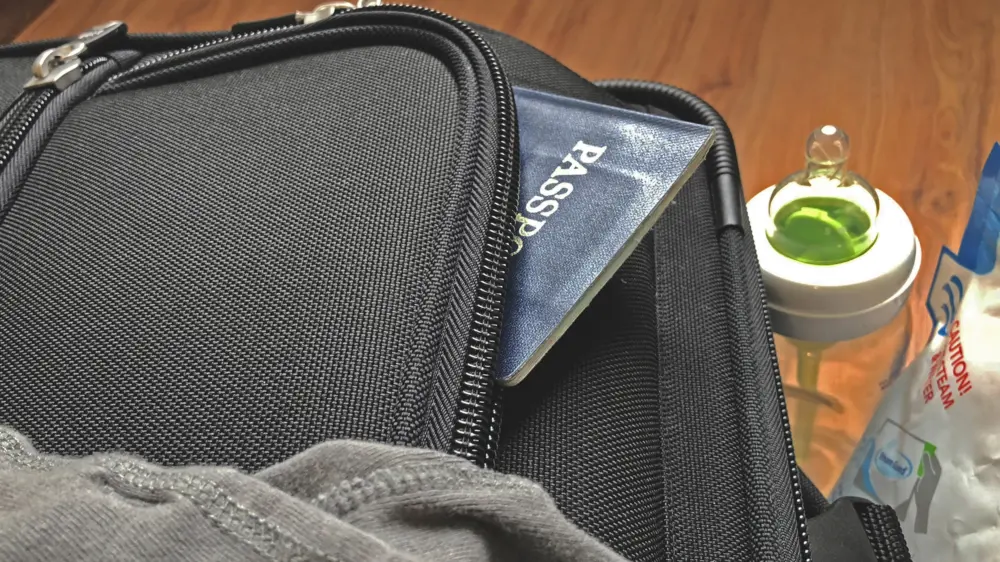 Travel passport in suitcase
