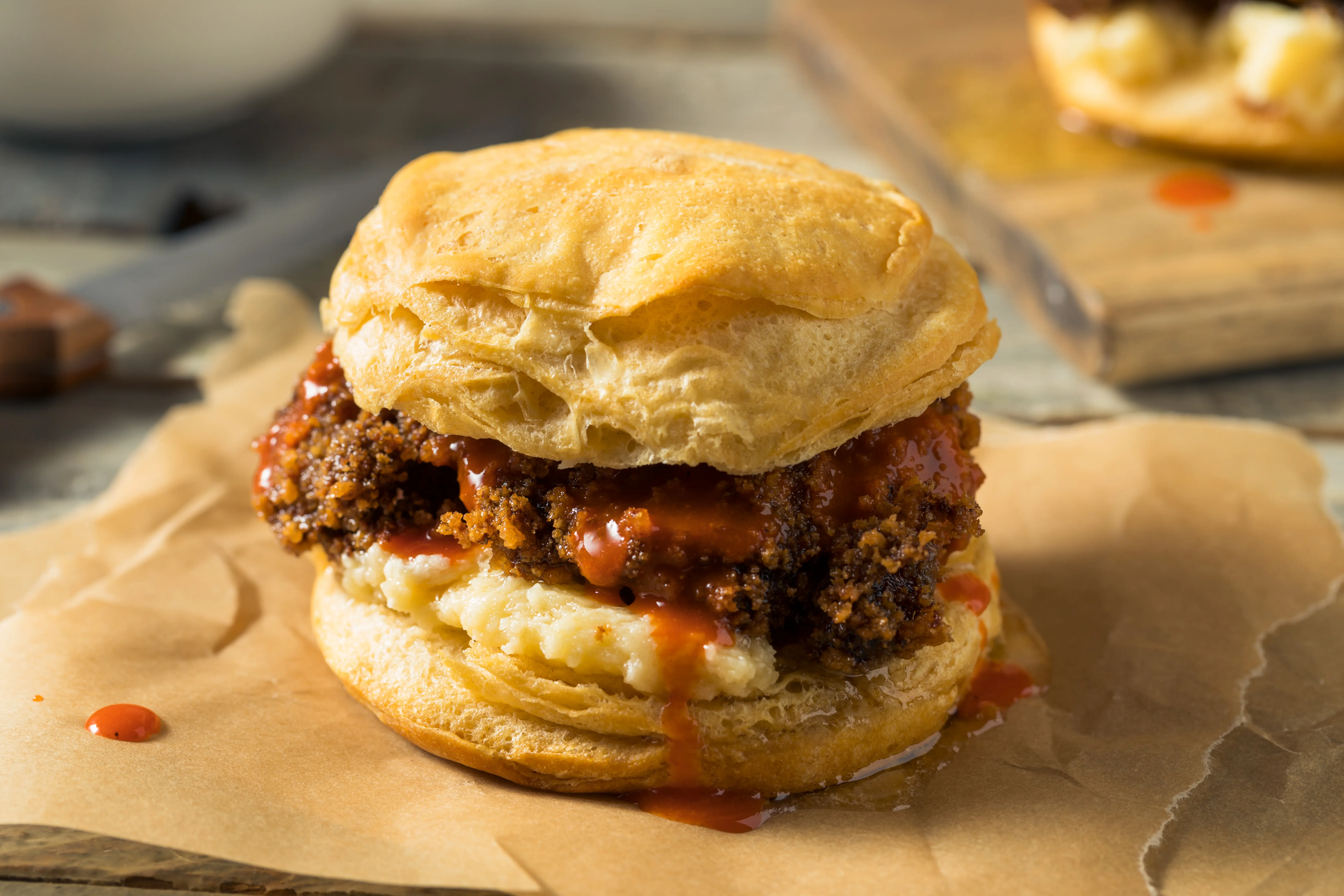 Image of a chicken biscuit with honey butter sauce.