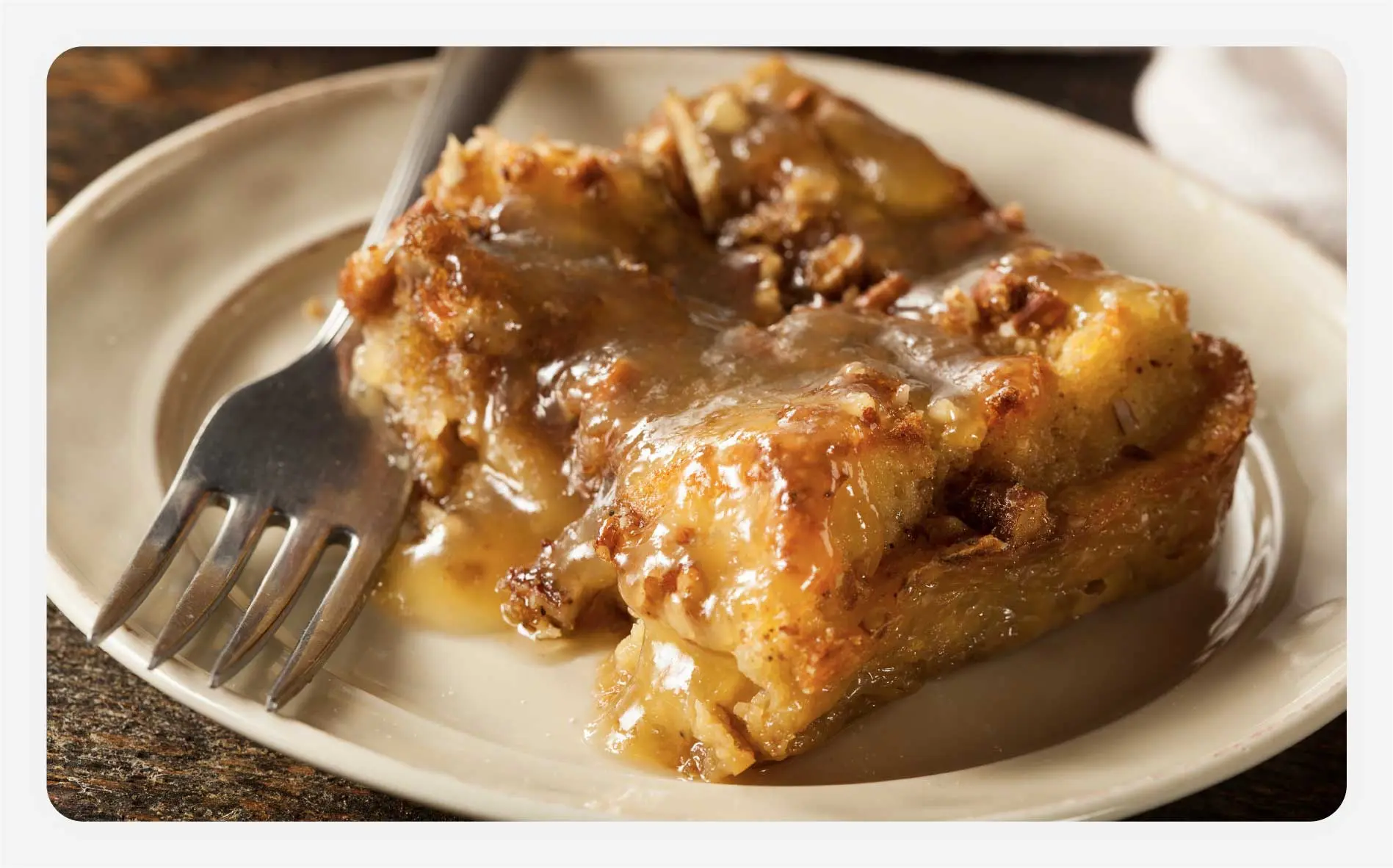 A plate of freshly baked bread pudding with a fork.