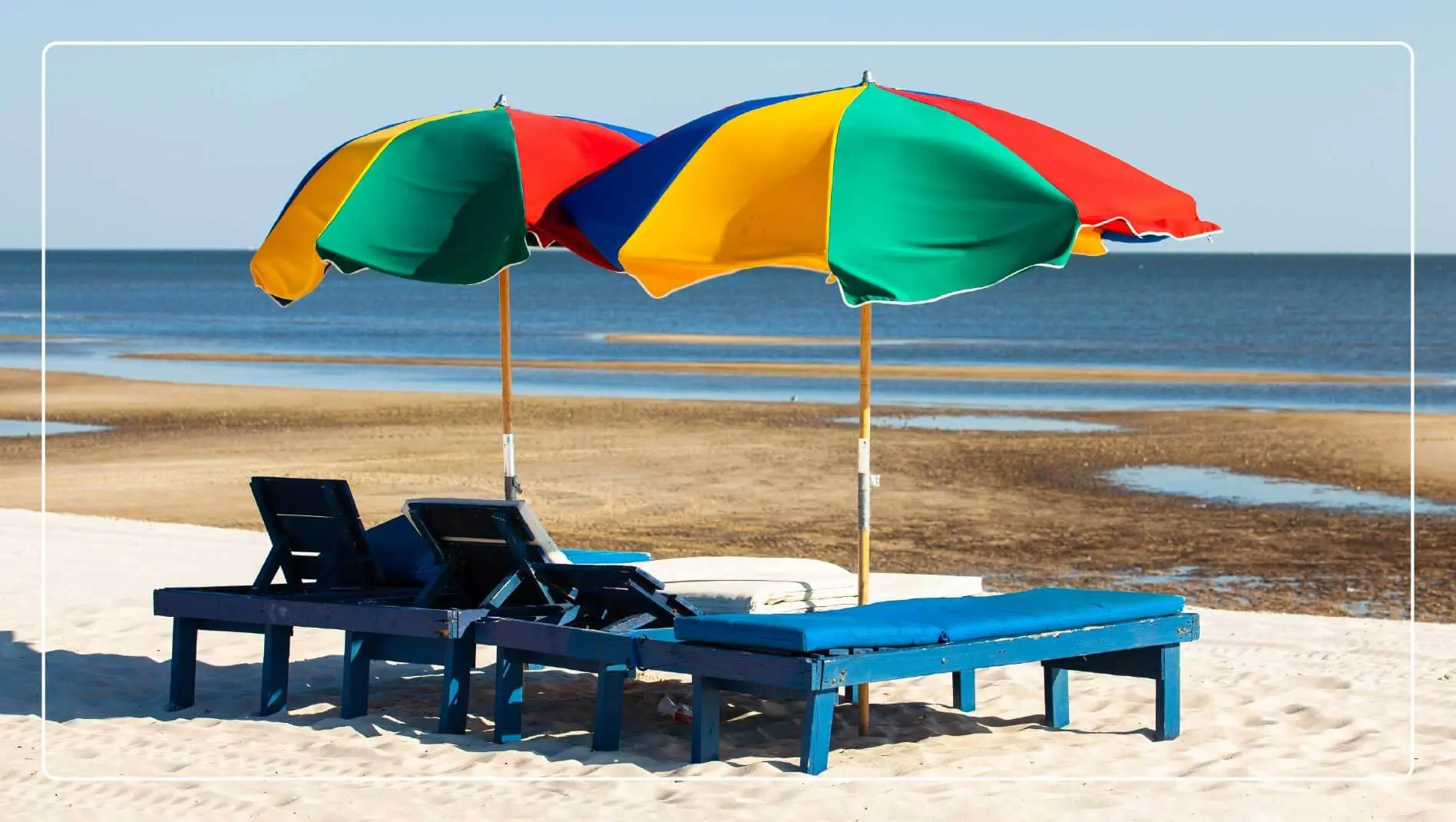 Lounge chairs and umbrellas face the water at Biloxi Beach, Mississippi.