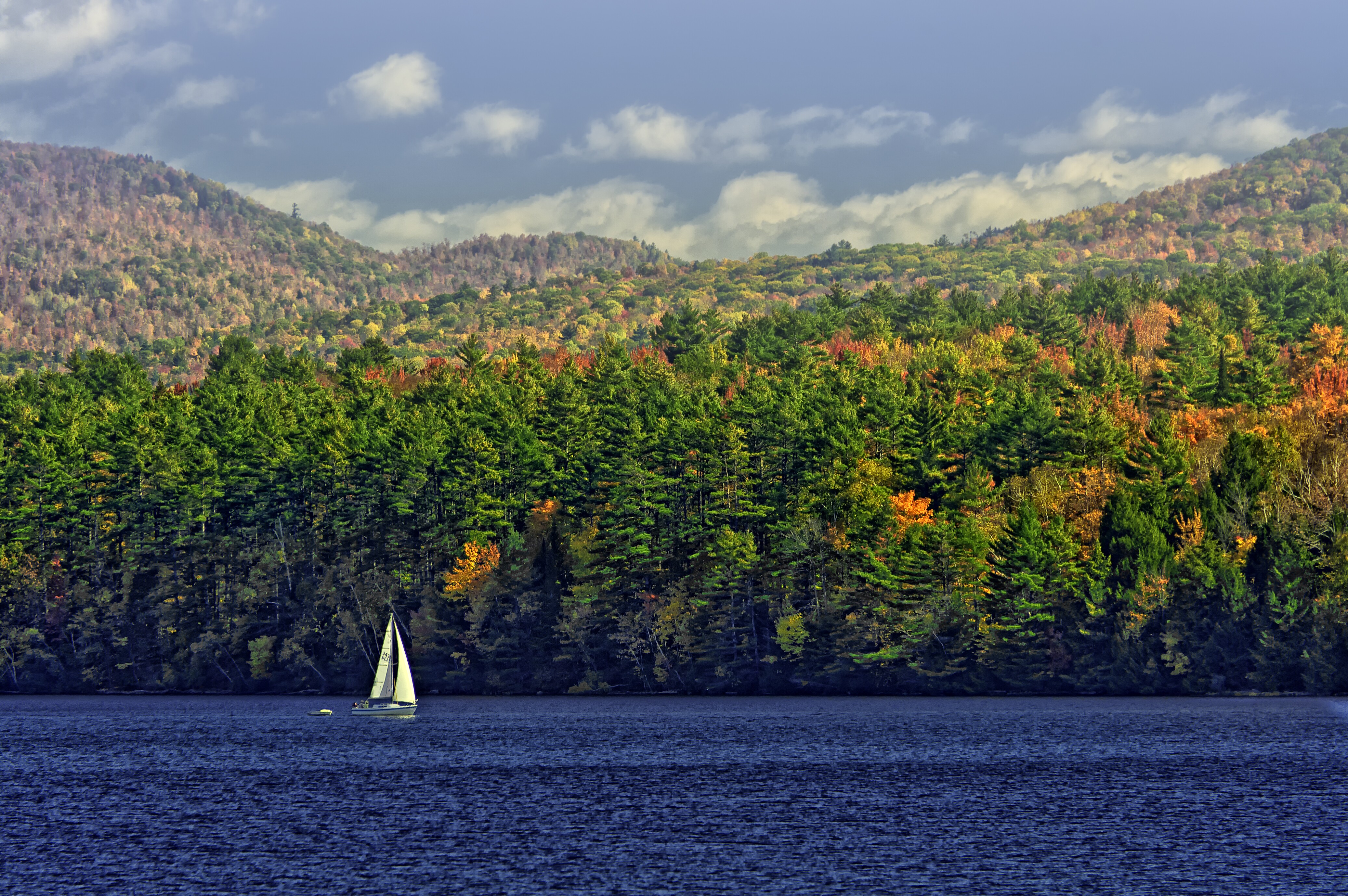 Sailboat on the water during the fall season, at Lake Champlain.