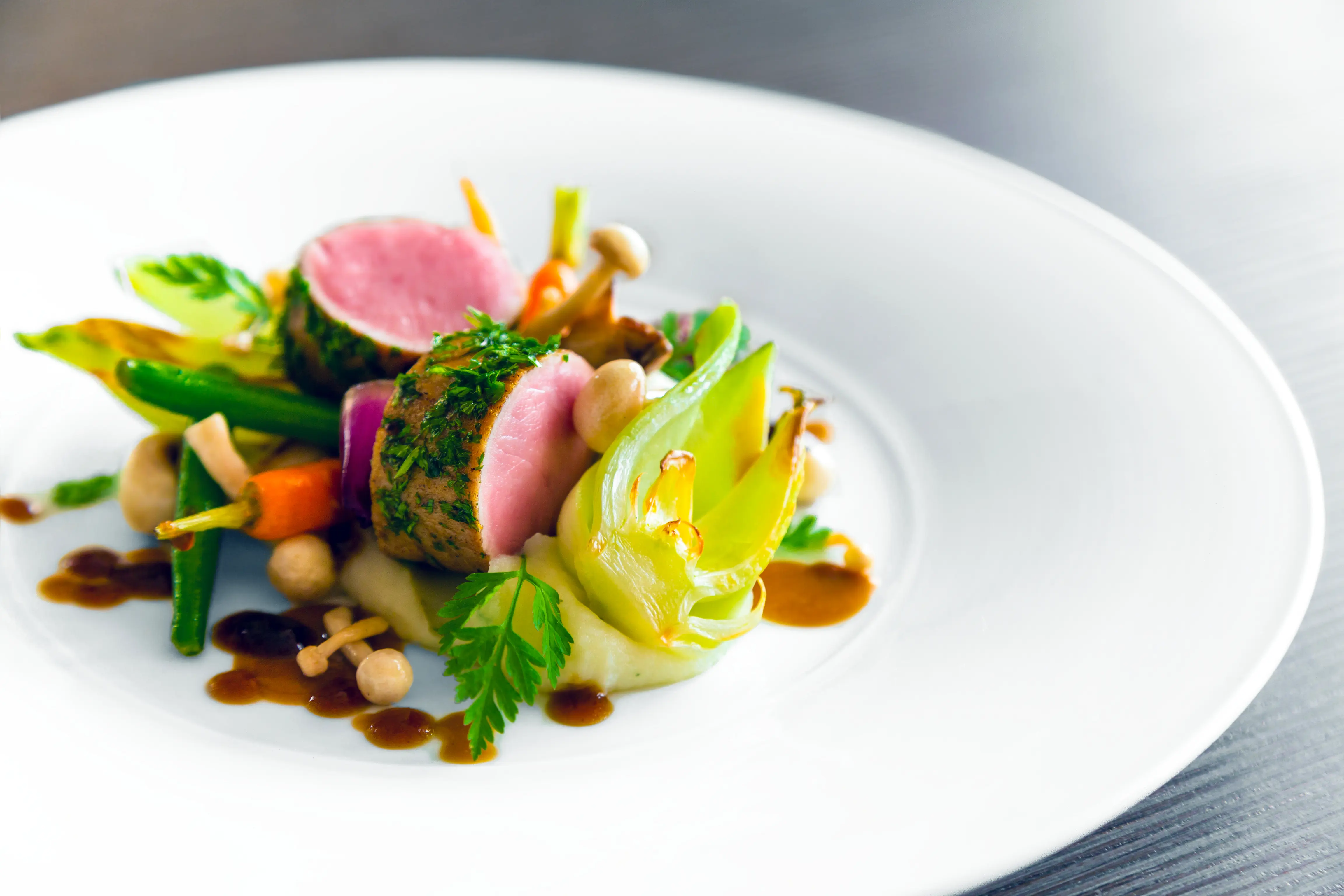 Herb crusted beef tenderloin, medium rare, with vegetables