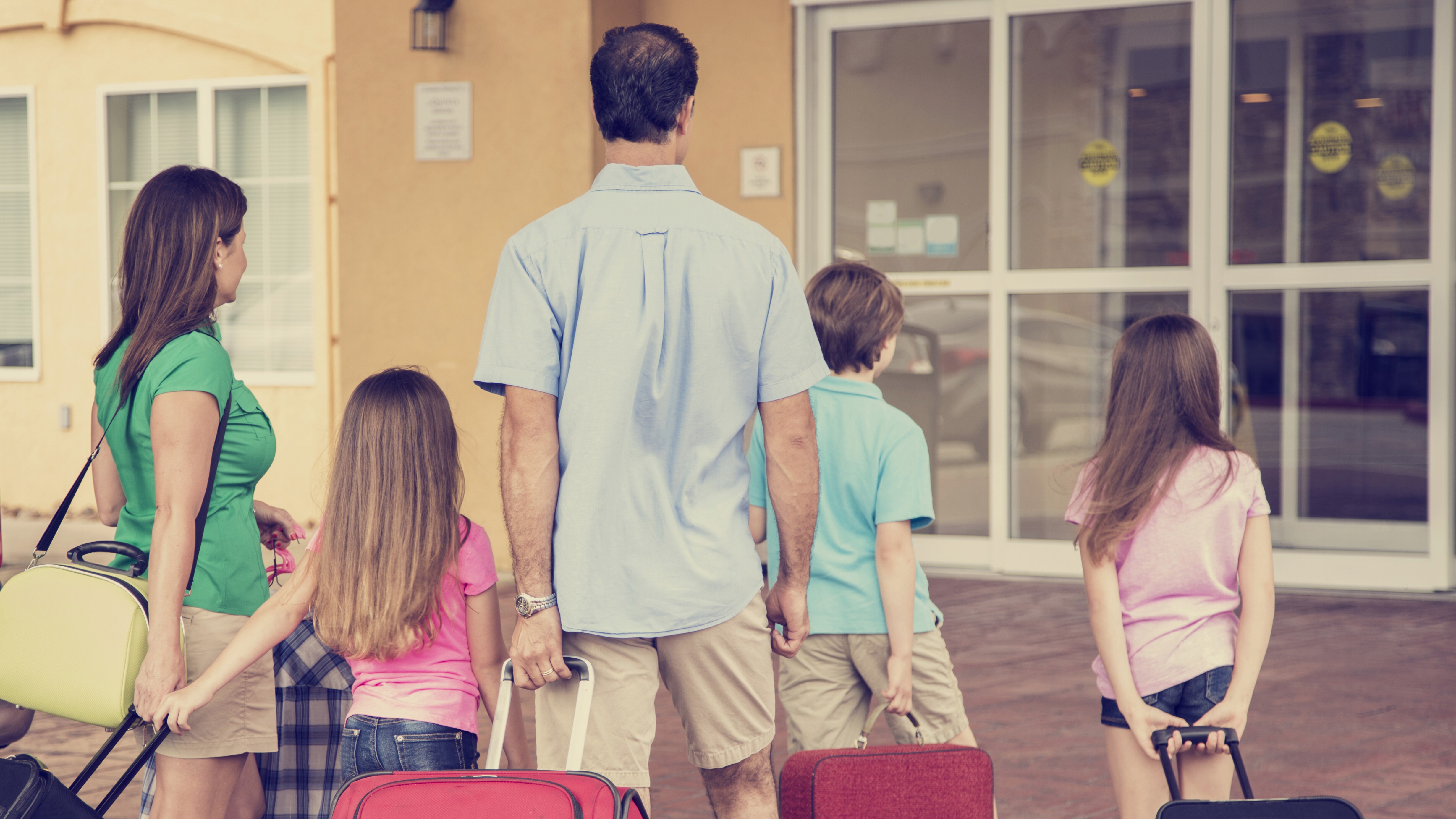 Family traveling with suitcases