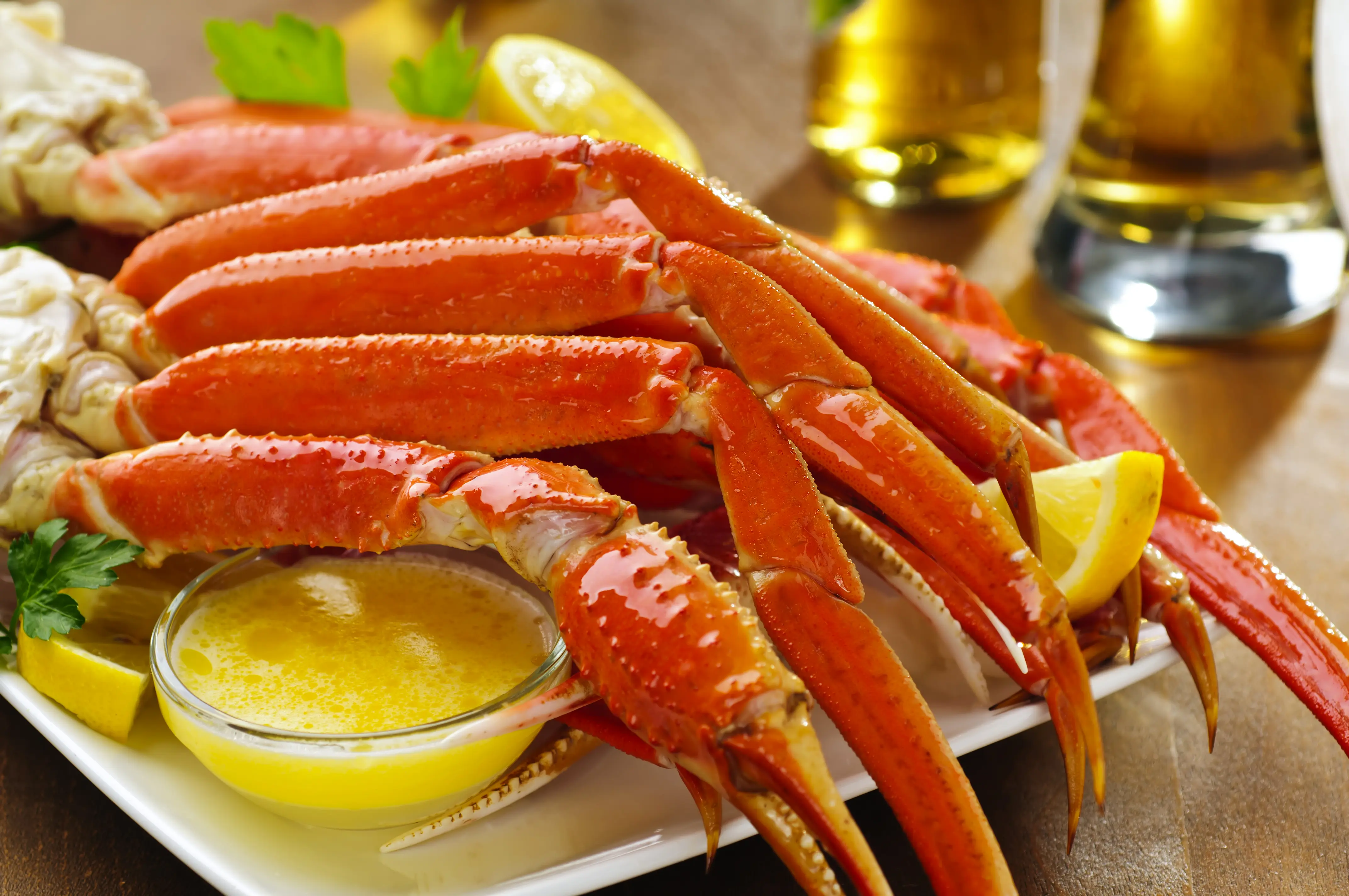 Snow crab legs with lemon wedges and melted butter