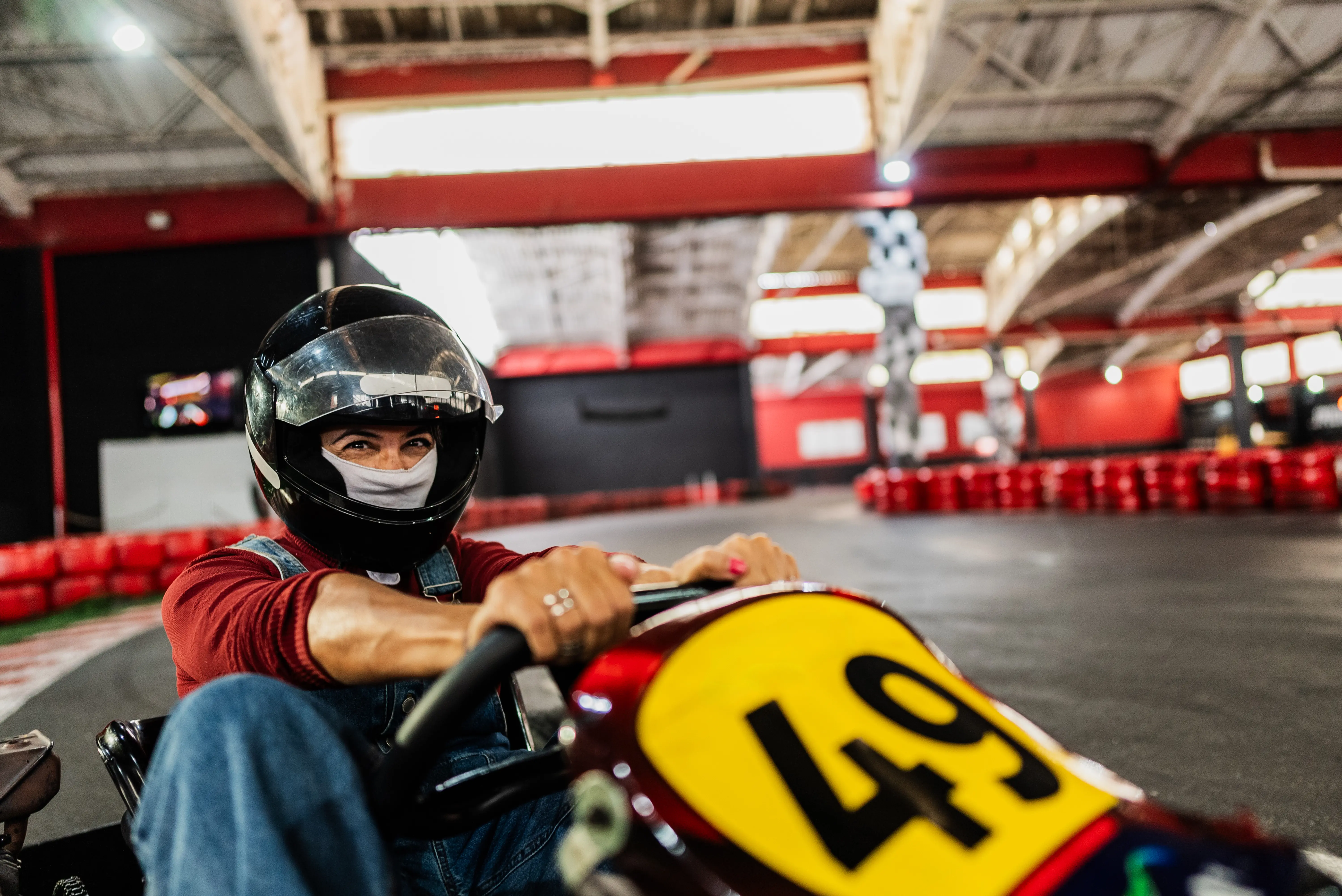 Image of someone riding a go kart on an indoor track.