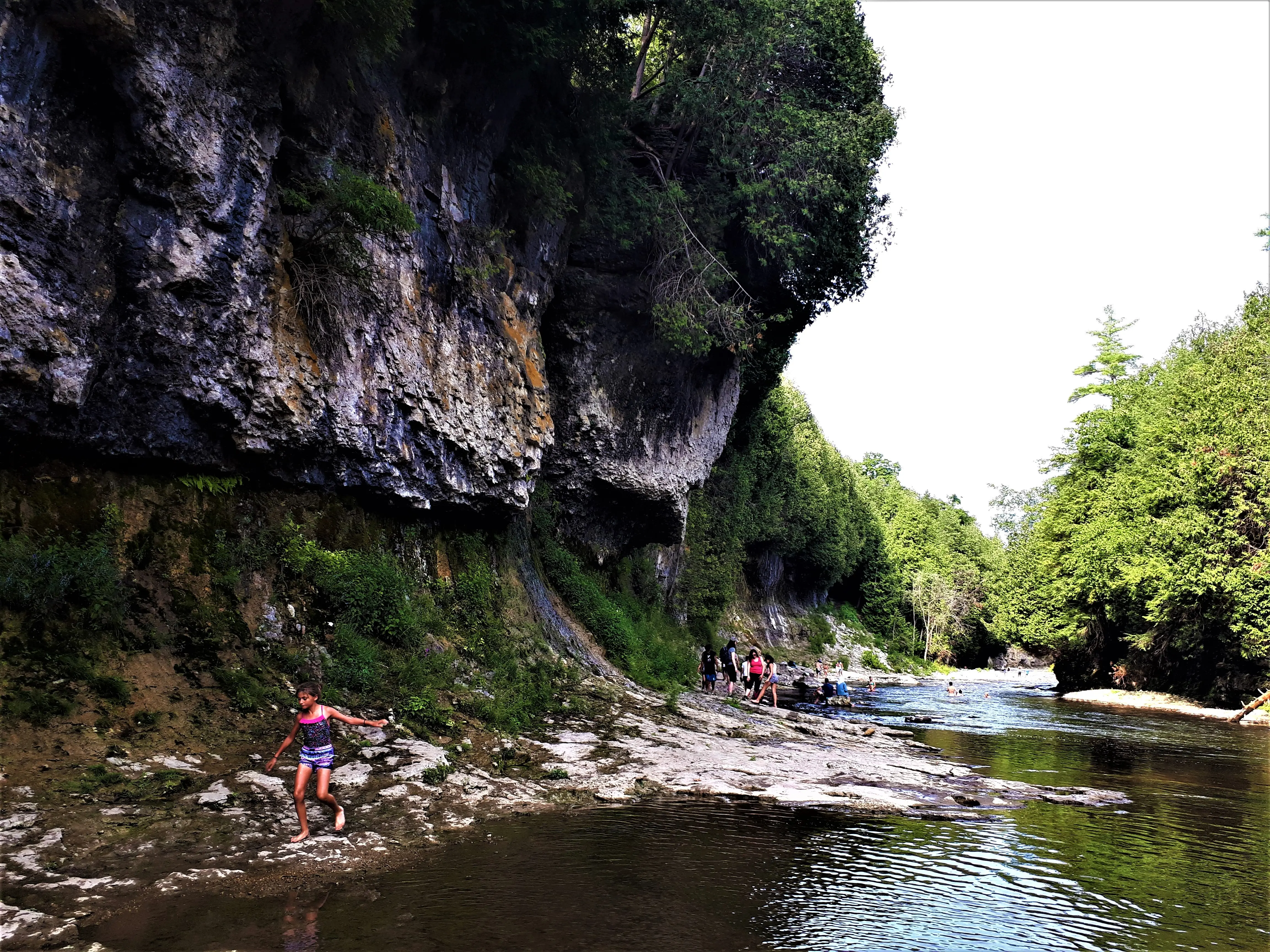 Image of visitors exploring the riverbanks of Elora Gorge