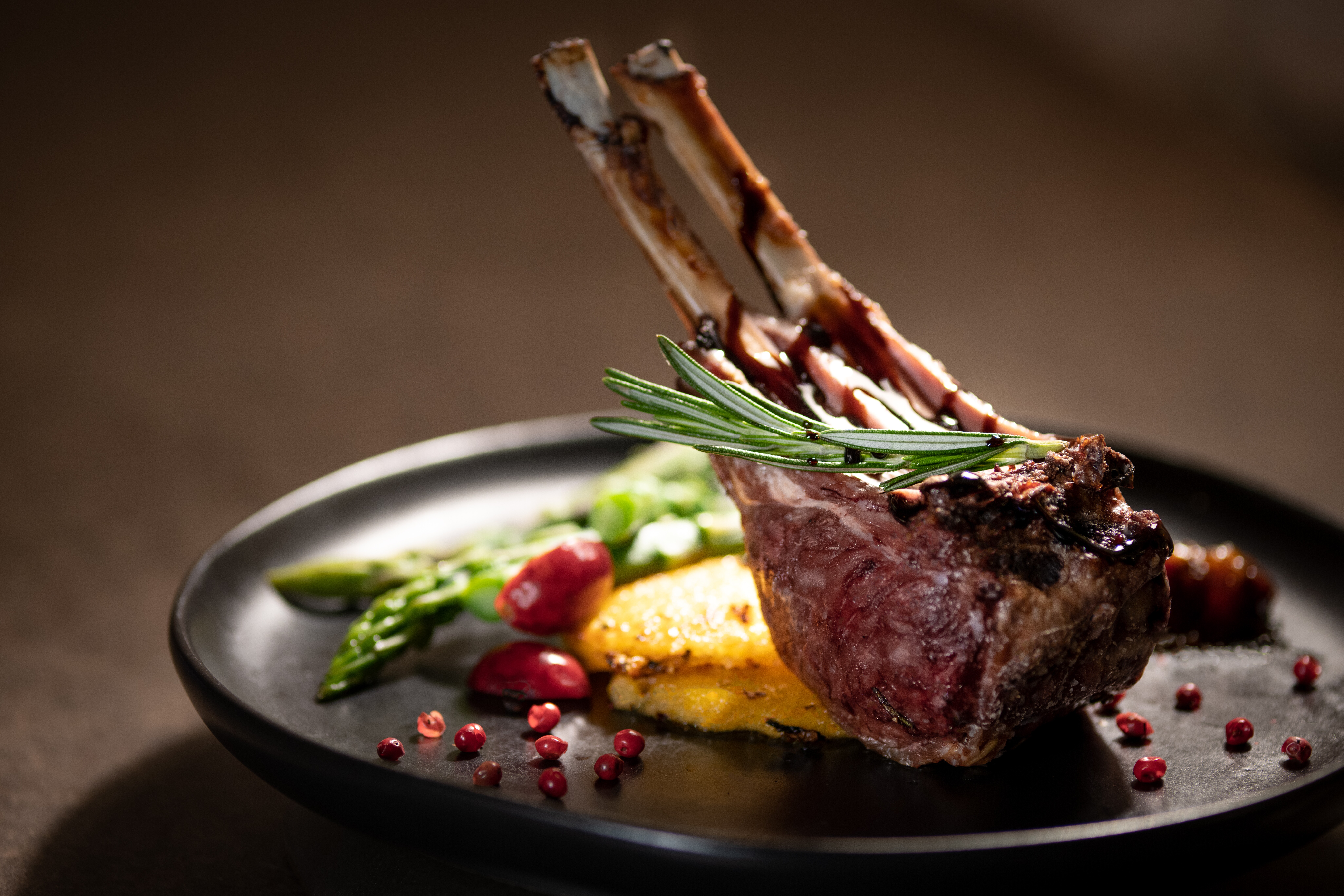 Closeup image of a rack of two grilled French cut lamb chops.