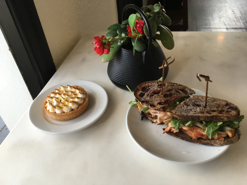 Lemon tart. Turkey and prosciutto sandwich on cranberry walnut bread