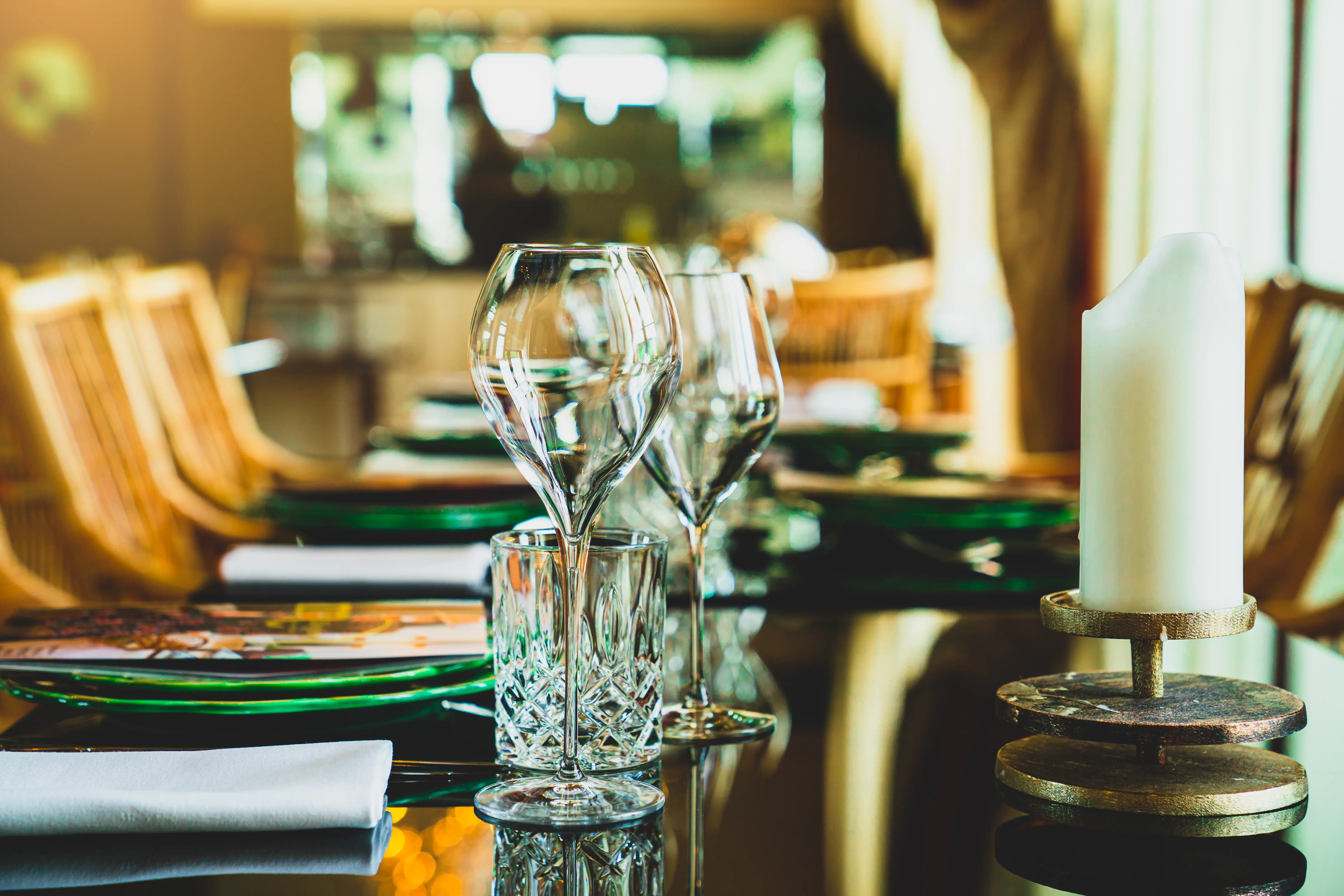 Closeup image of wine glasses on a table at a fancy restaurant.