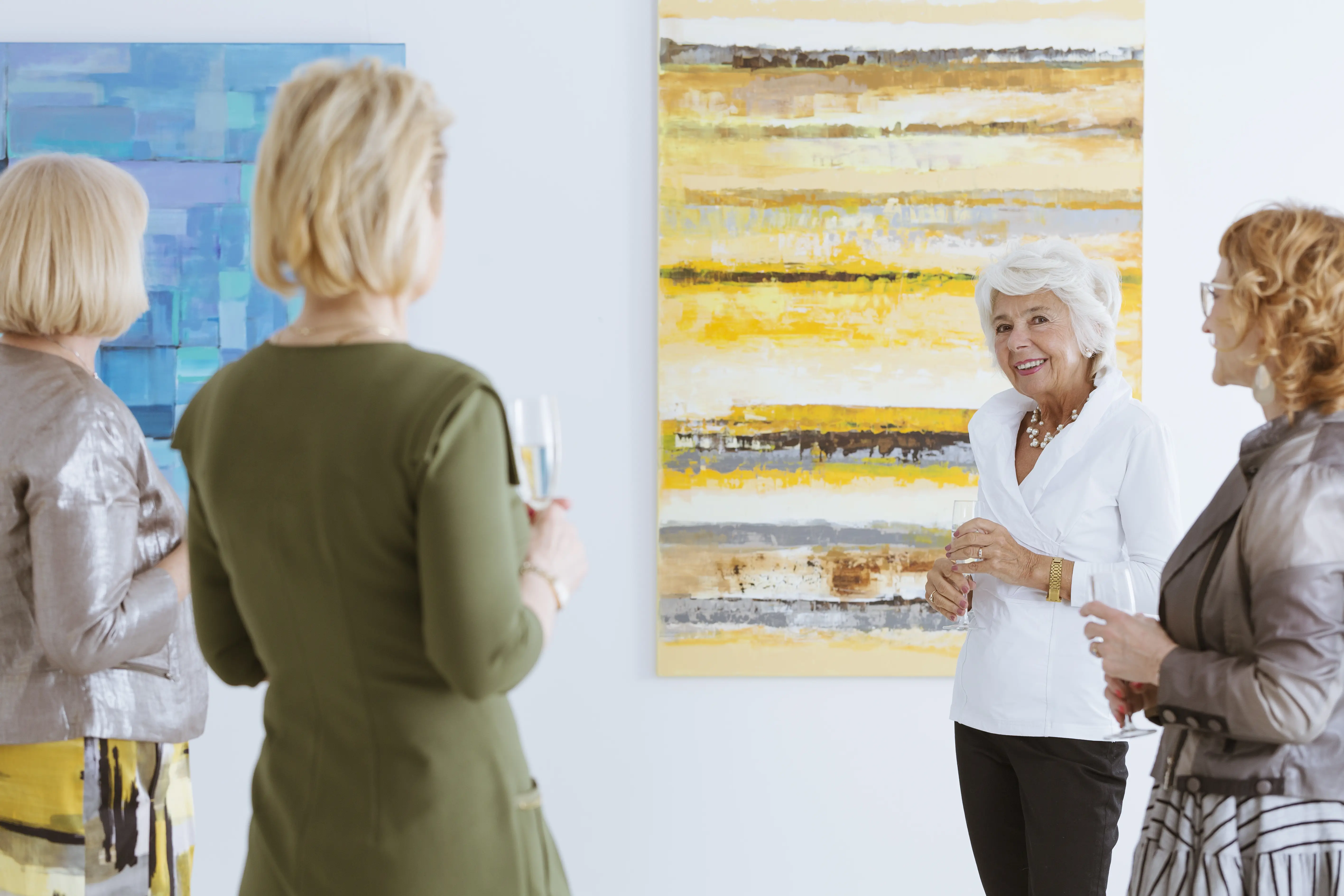 Patrons at art museum drinking wine