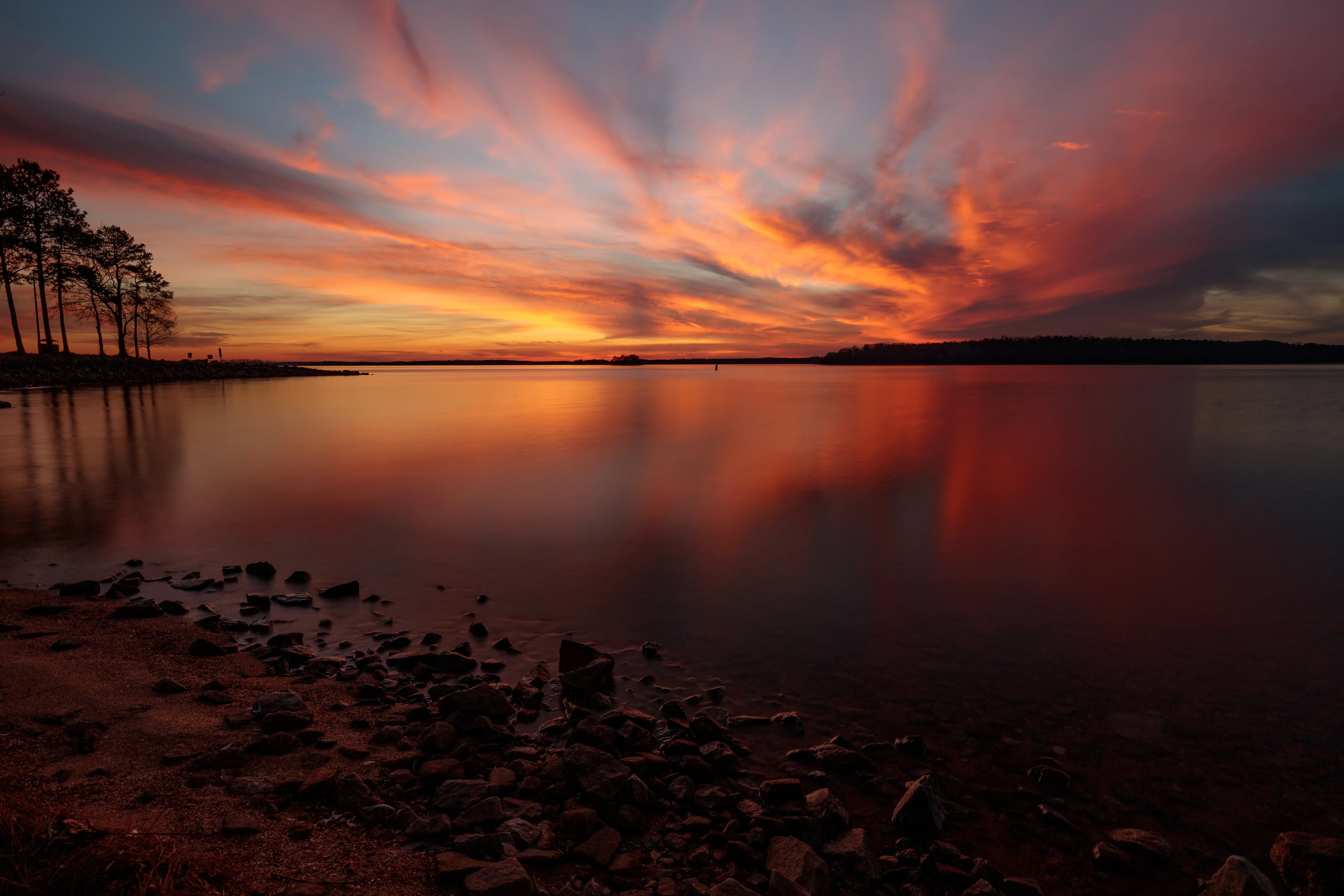 Image of a scenic view of sea against orange sky, Anderson, South Carolina.