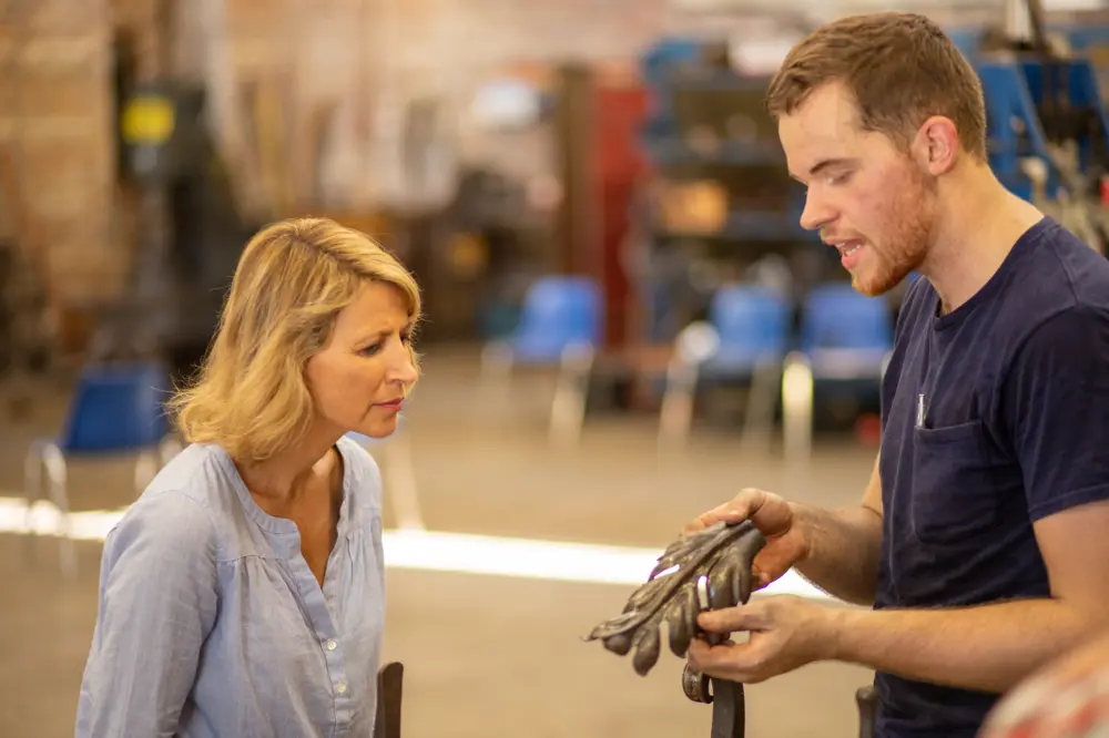 Samantha Brown being shown some metal art