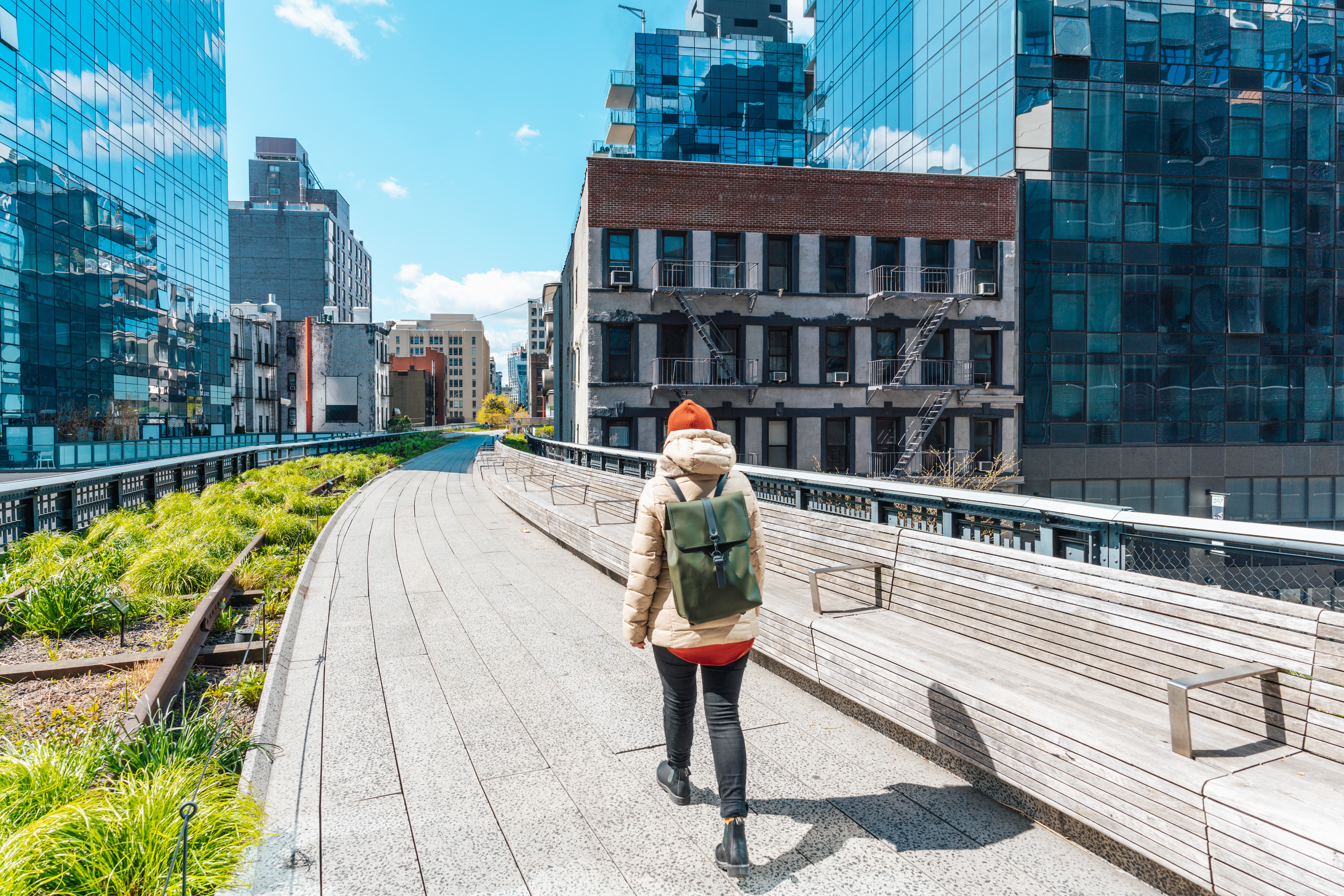 Image of a person walking through the The High Line park in New York City.