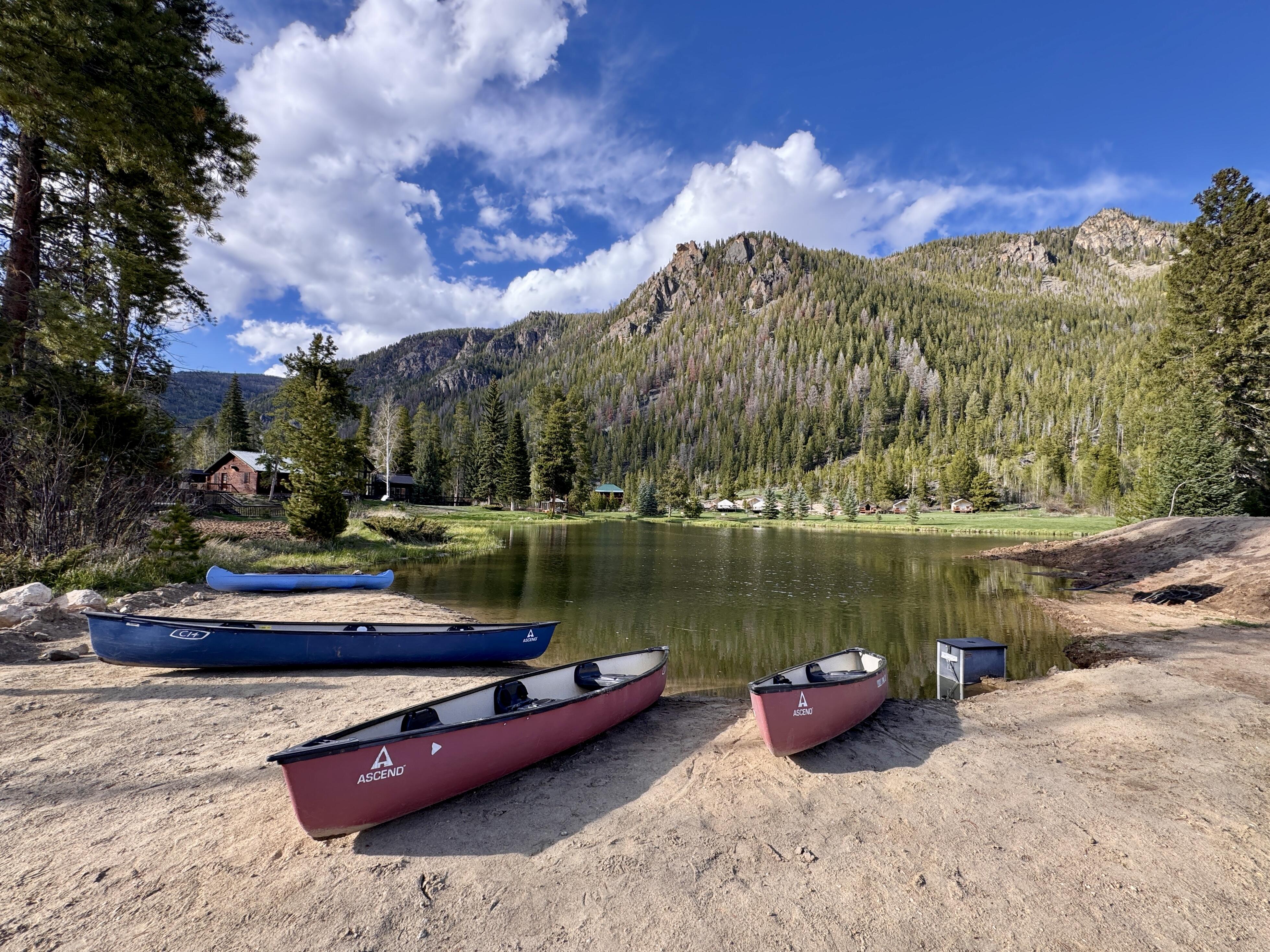 Image of canoes sitting on the shore of Monarch Lake.