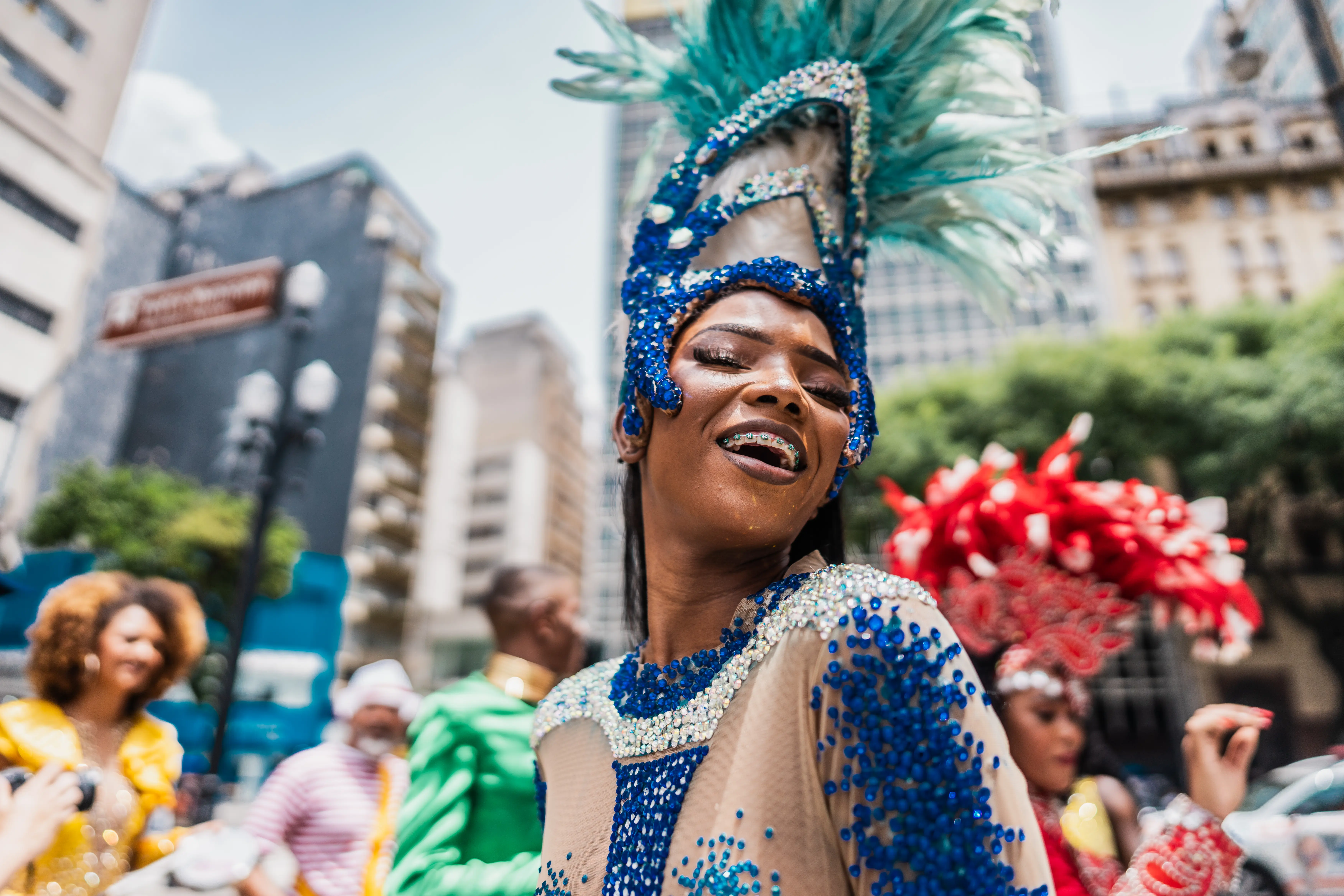 Photo of a woman celebrating in lively colors at a street carnival party in Rio, Brazil