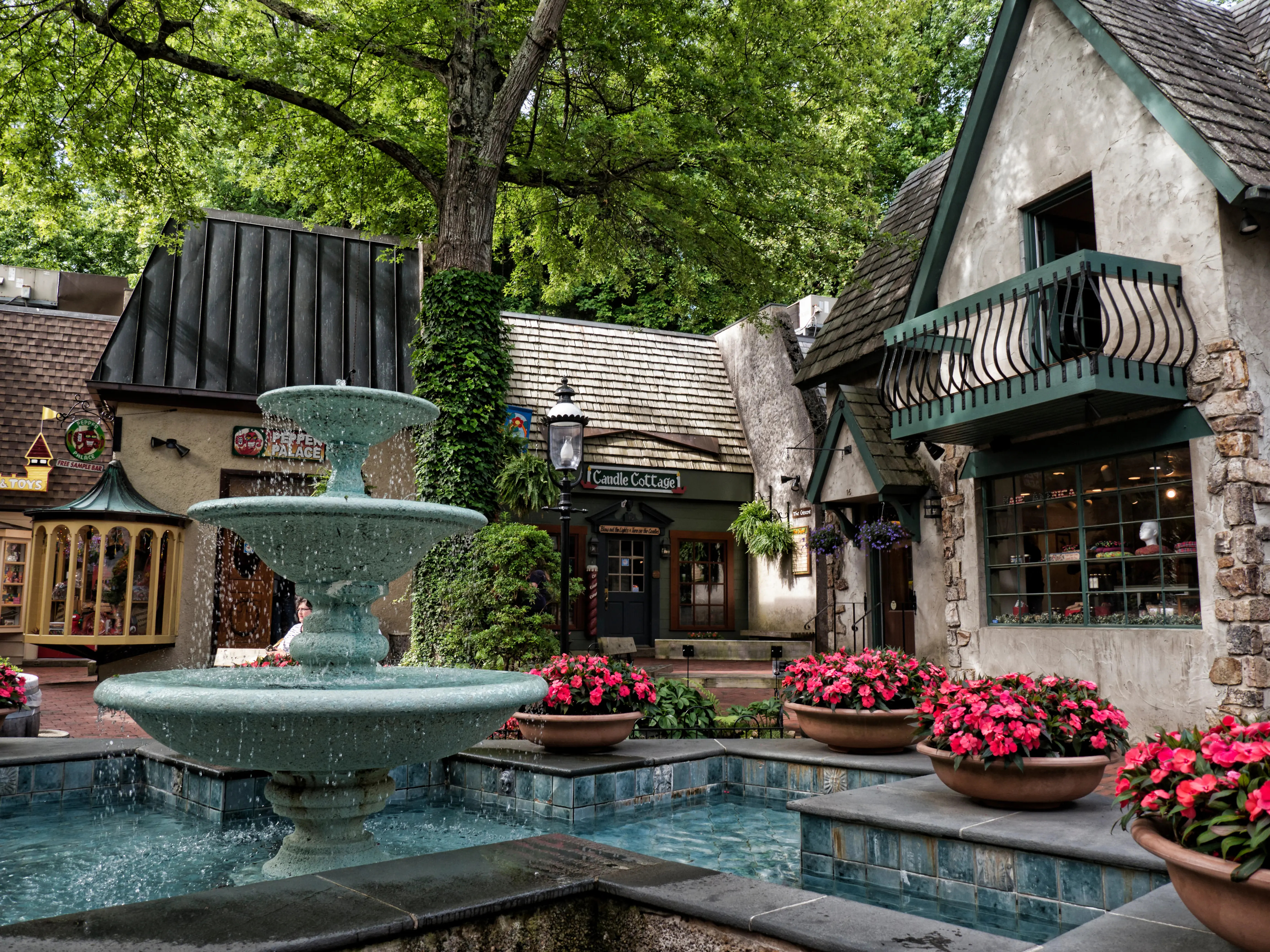 Quiet corner of quaint stone building shops and fountain with pink flowers, in the holiday resort of Gatlinburg in Tennessee USA