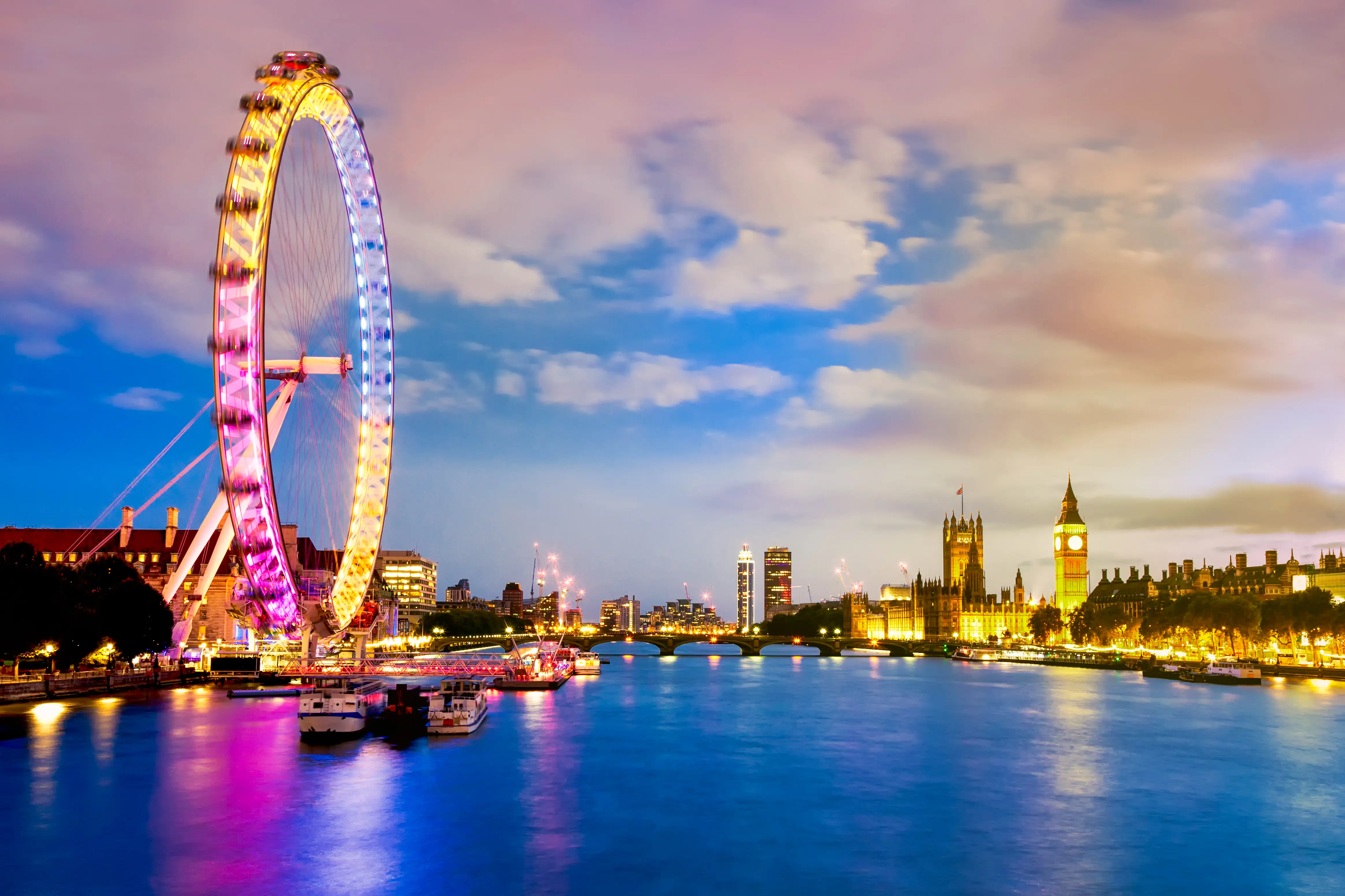 London Eye on River Thames, with Westminster Bridge, Palace of Westminster and Big Ben in background at night