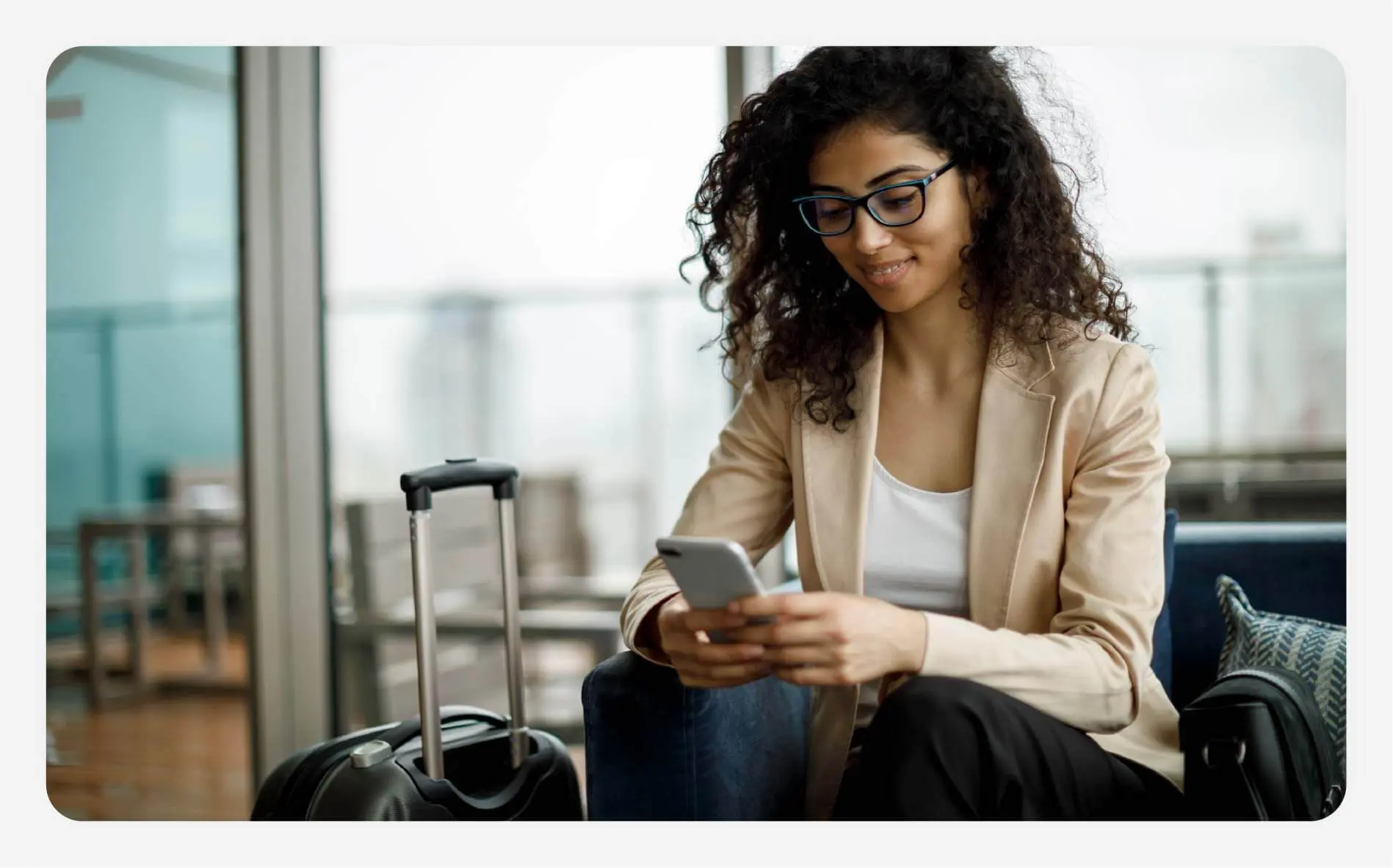 Solo female traveler tracking luggage on her phone